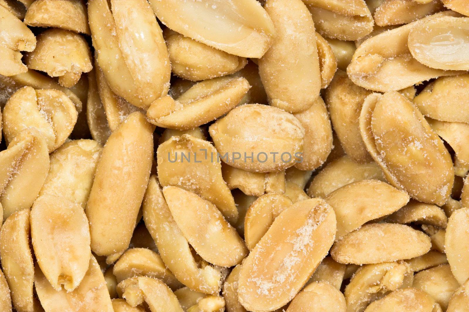 Detailed closeup of salted peanuts. The nuts fill the entire frame.