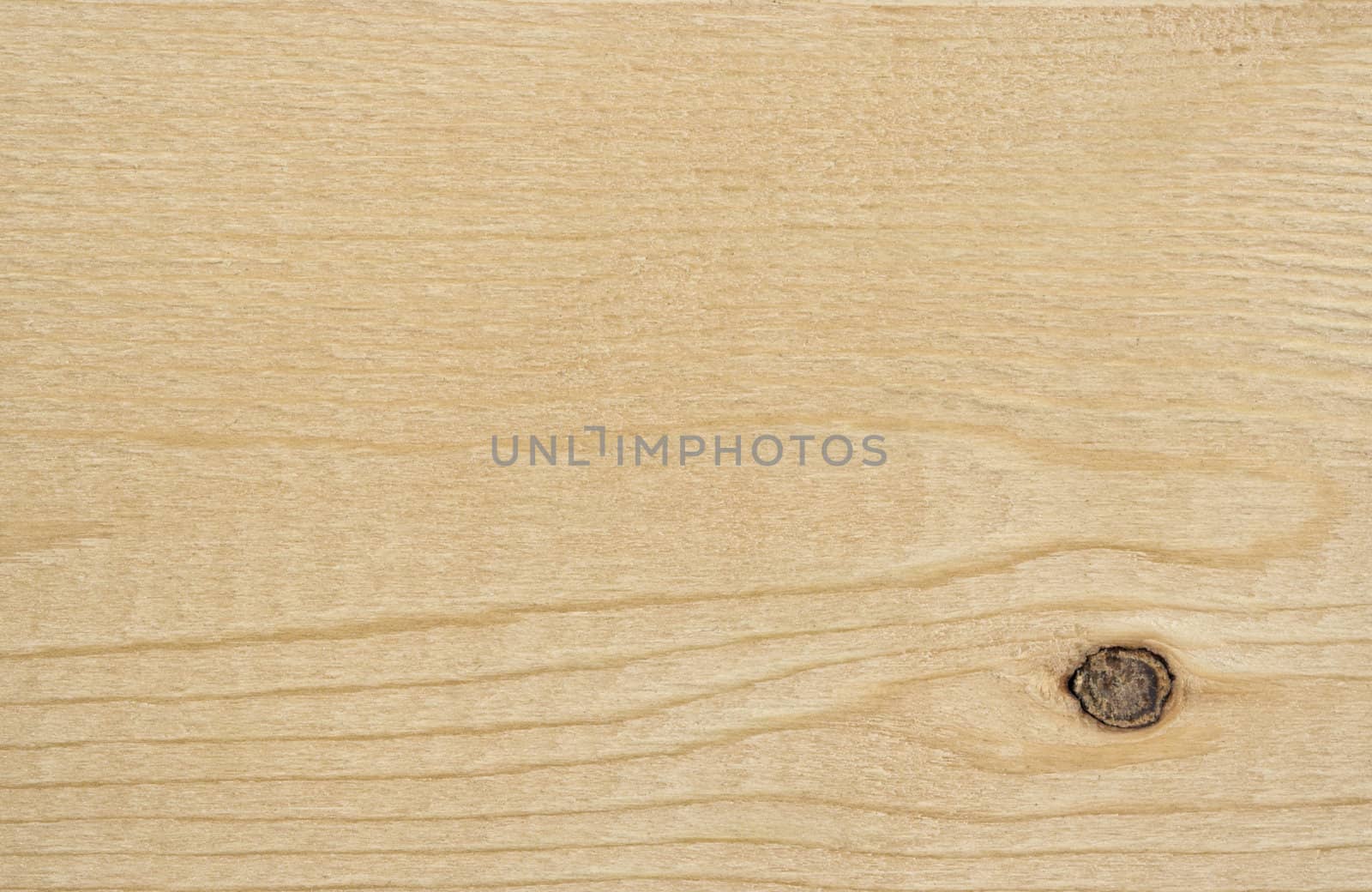 A wood background showing detail and texture. There is a knot in the lower left corner.