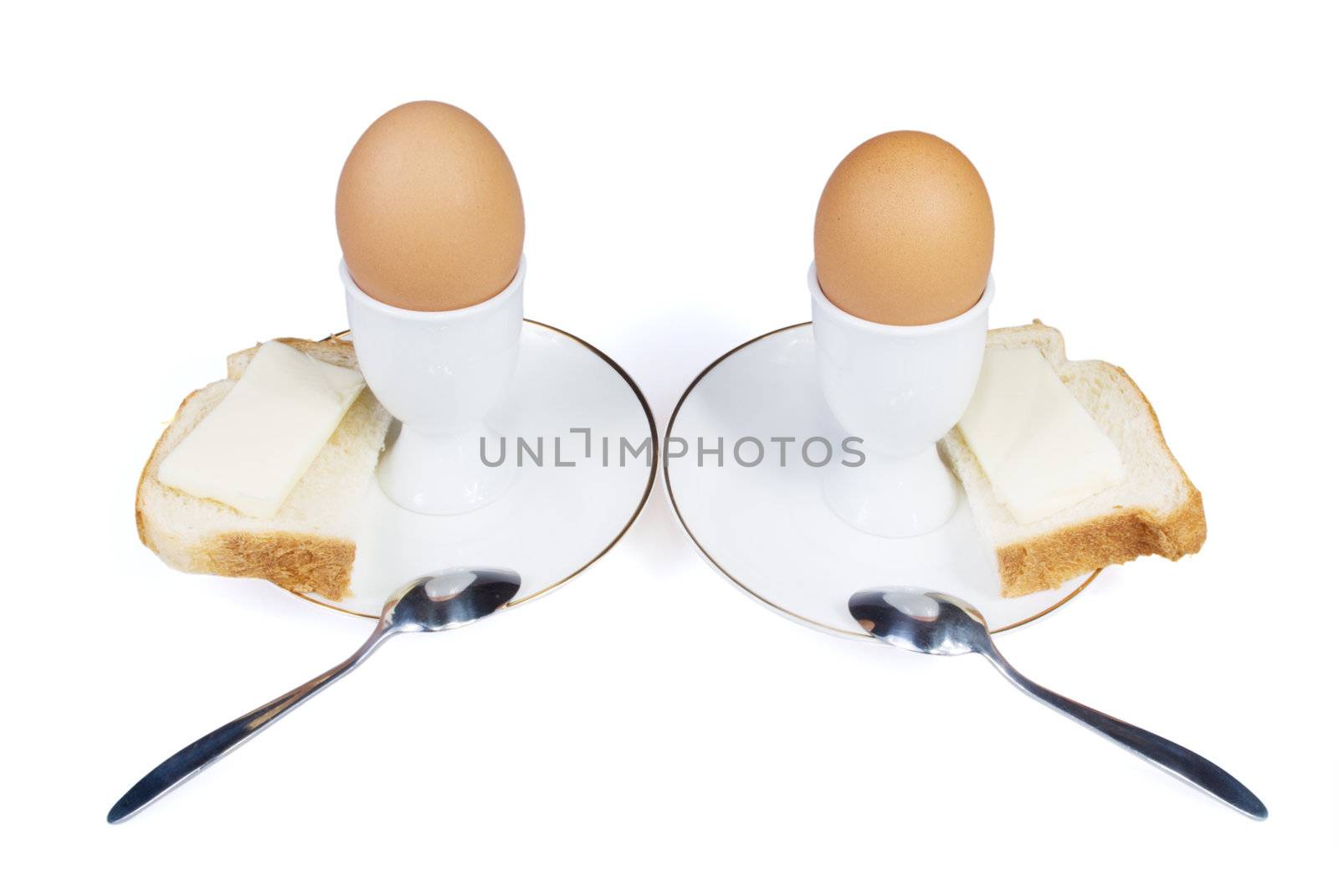 Eggs with bread and butter are on the white background