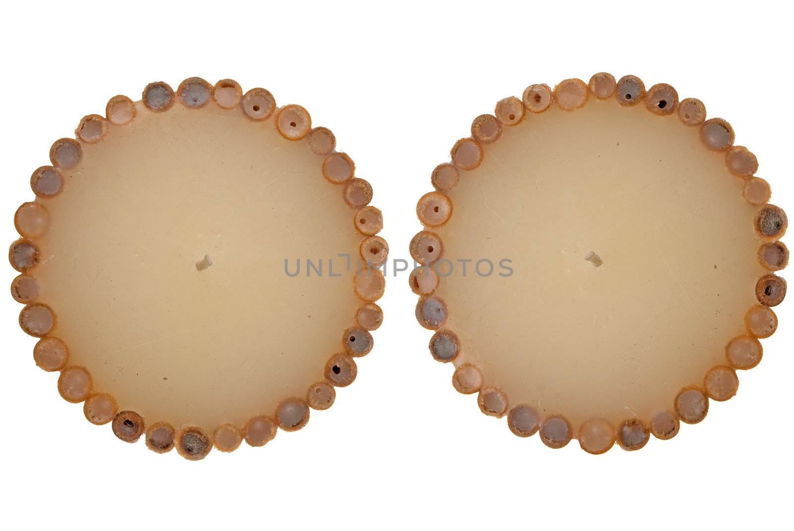 Top view of two decorated wax candle isolated on white background.