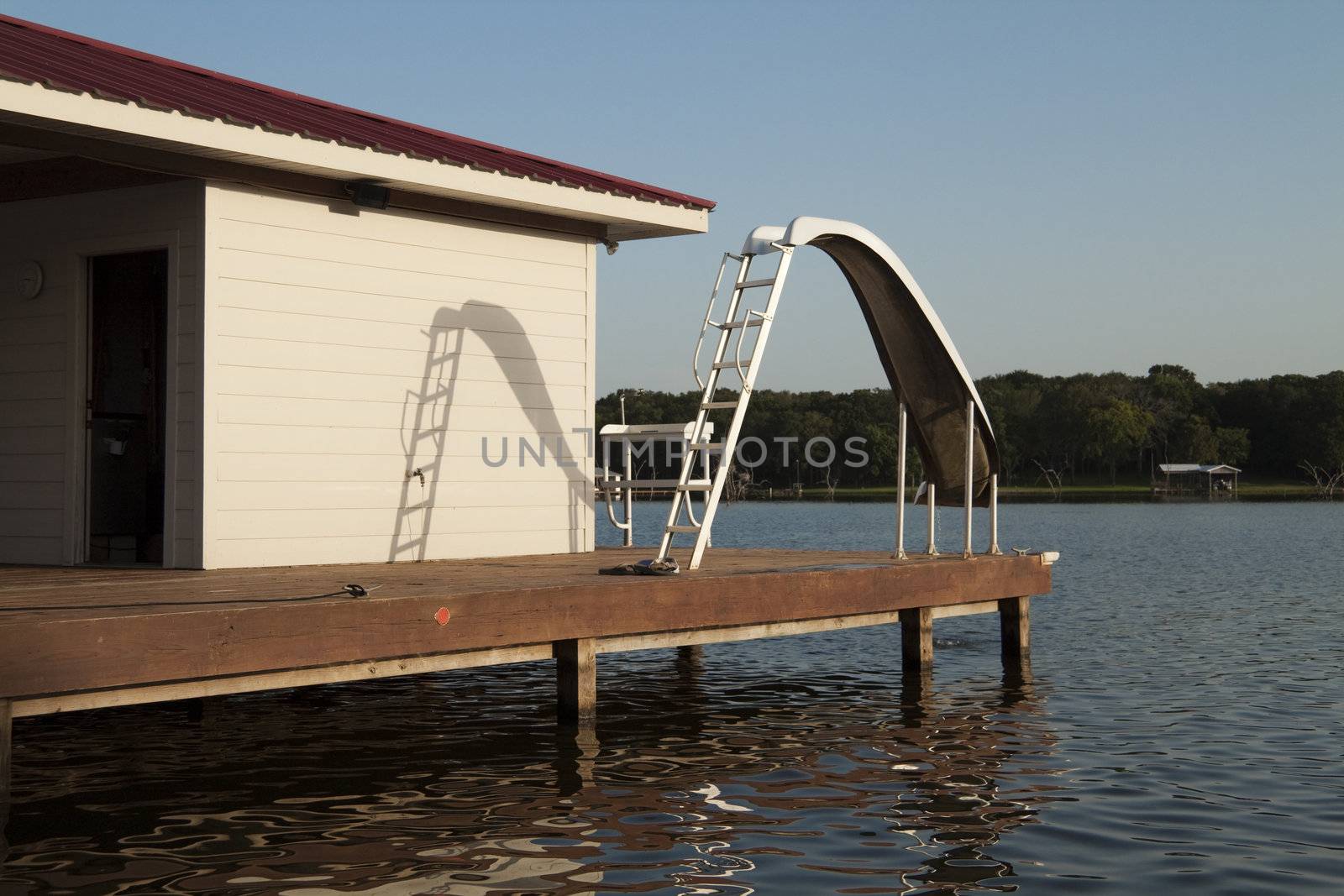 A waterslide on the end of a wooden dock