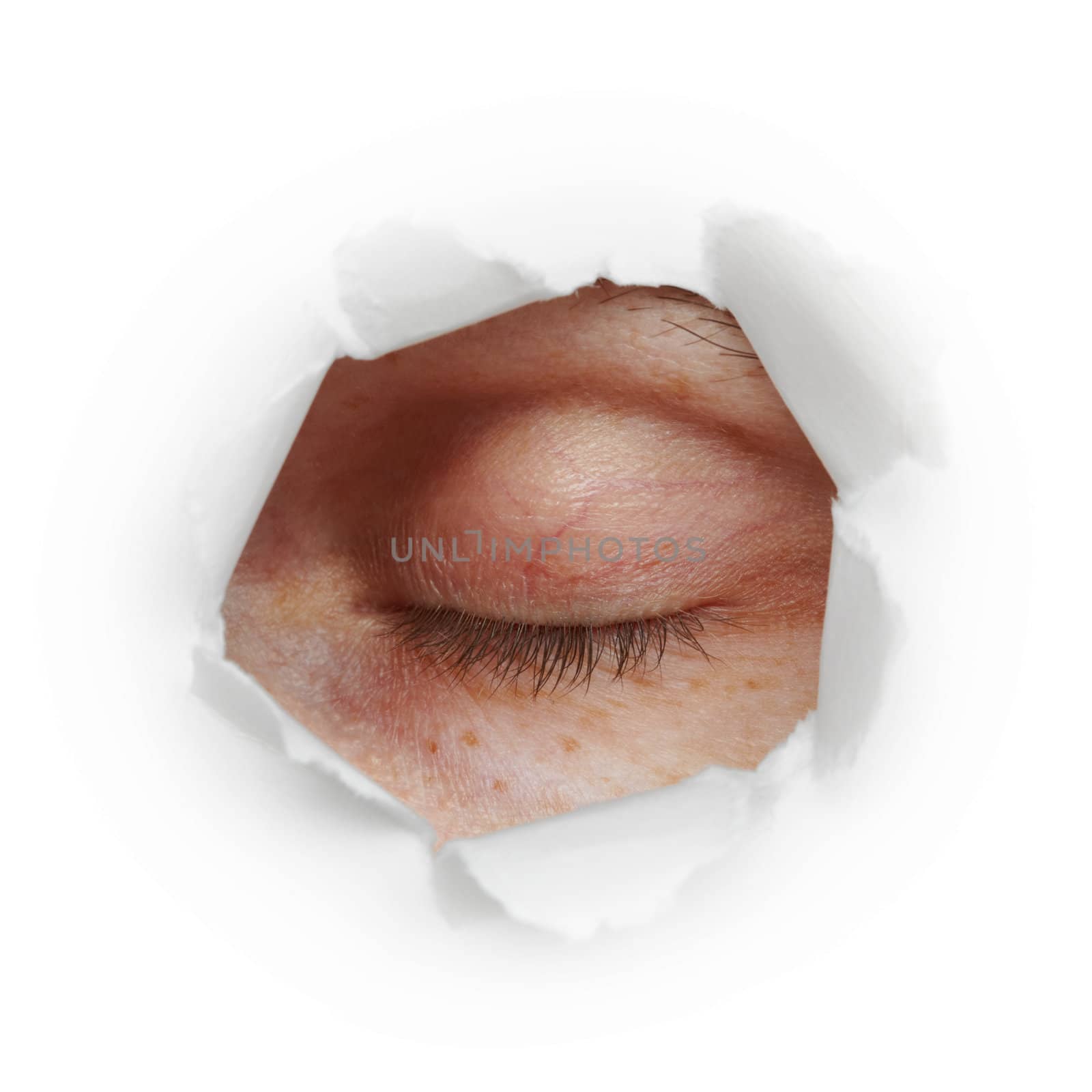 Closed human eye in a paper hole