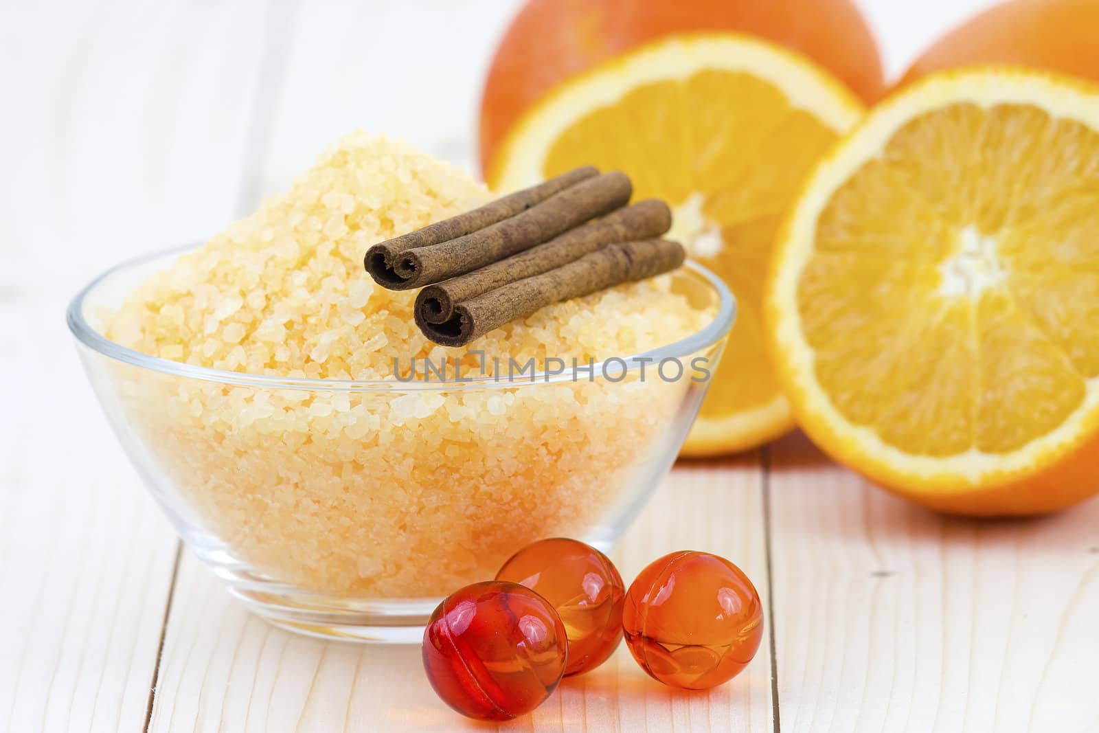bowl of orange bath salt with fresh fruits - beauty treatment