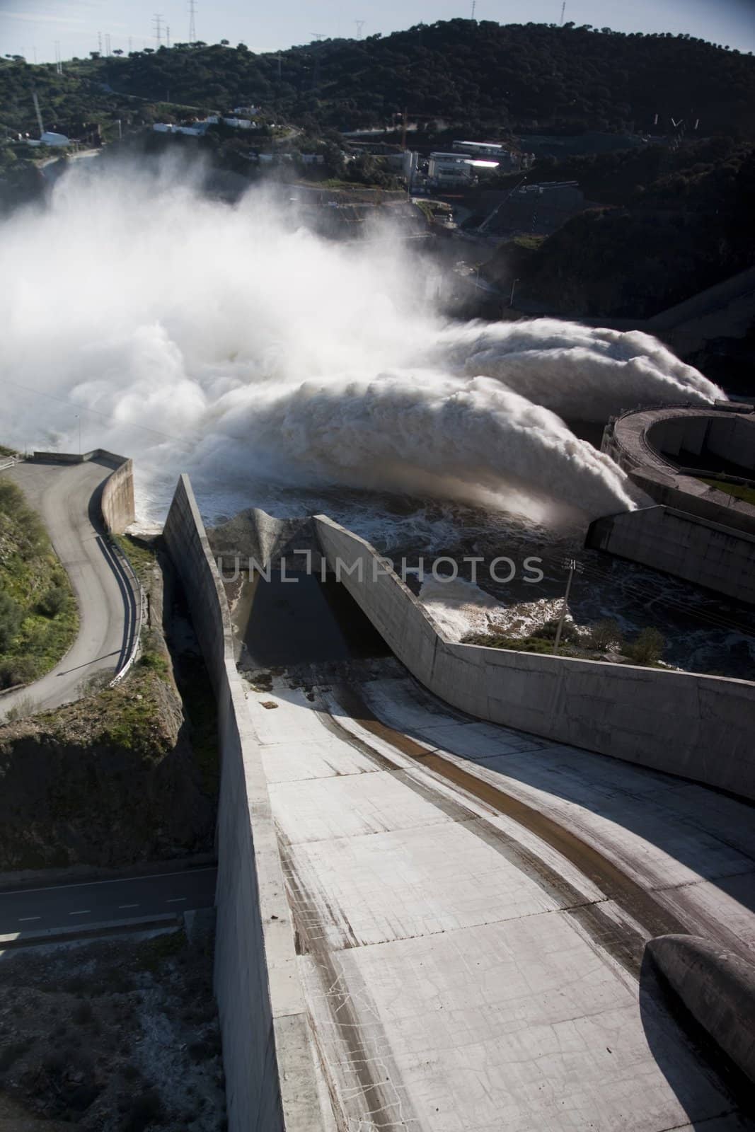 View of two powerful jets of water on the Alqueva dam, Portugal.