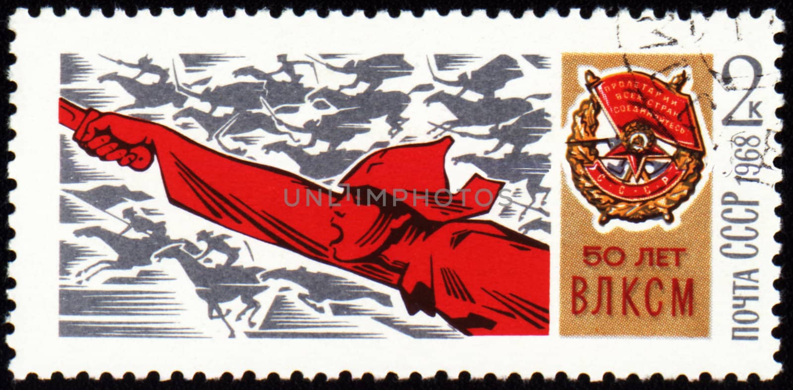USSR - CIRCA 1968: A stamp printed in USSR, shows riding on a horse soldier with a sword and Order of the Red Banner, devoted to the 50-th anniversary VLKSM, circa 1968