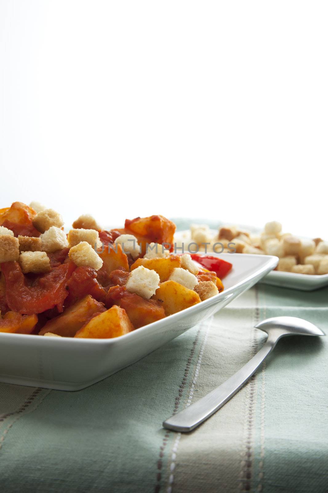 Vegetarian version of hungarian goulash with potatoes and peppers and croutons.