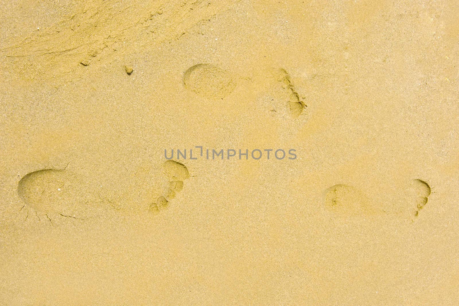 three footsteps in the sand