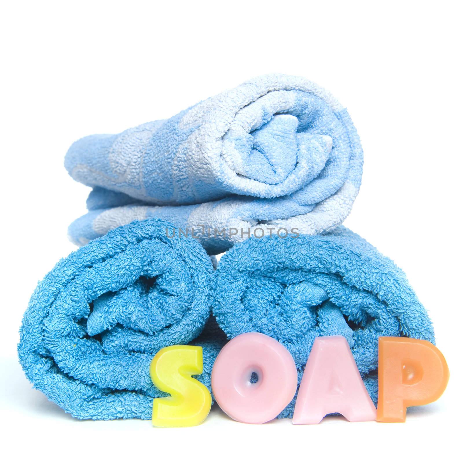 a blue towel and soapletters spelling "soap"