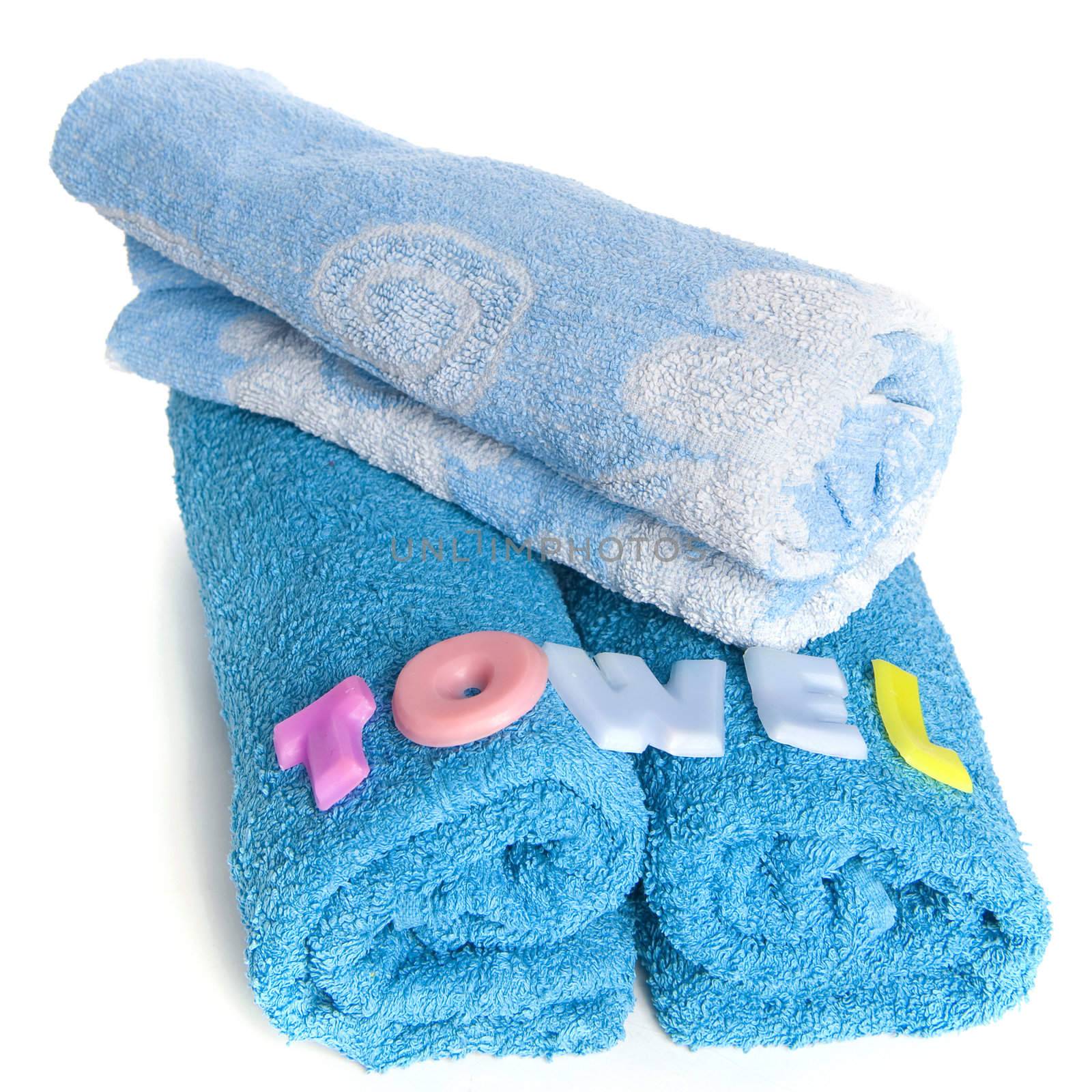 a blue towel and soapletters spelling "towel"