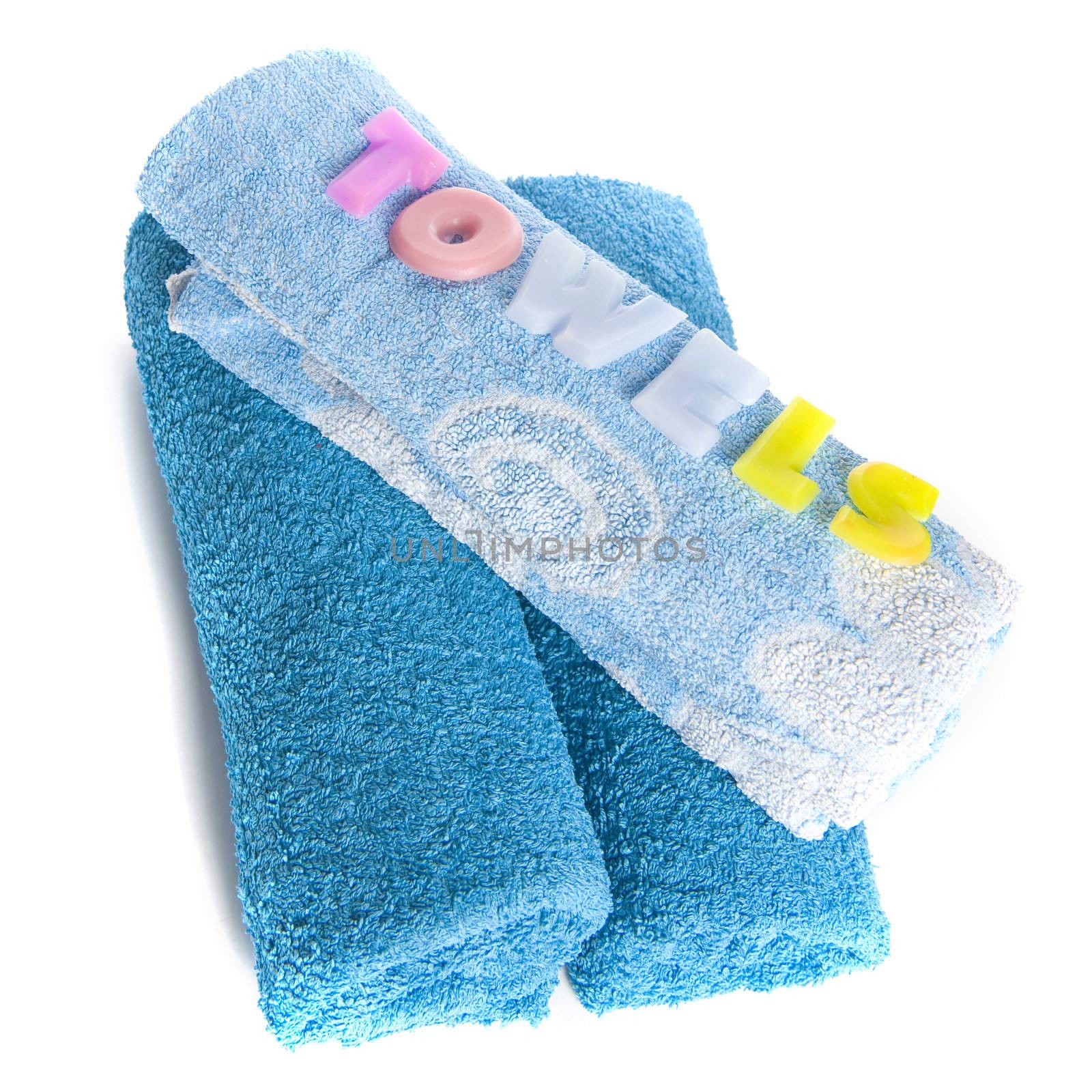 a blue towel and soapletters spelling "towels"
