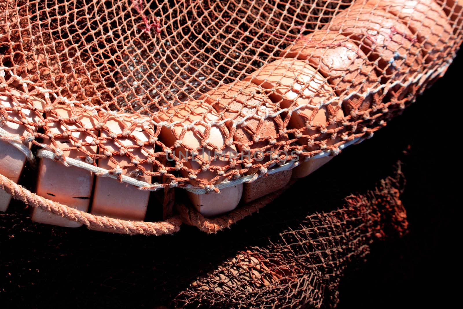 Close detail of some fishing net and orange floaters on the docks.