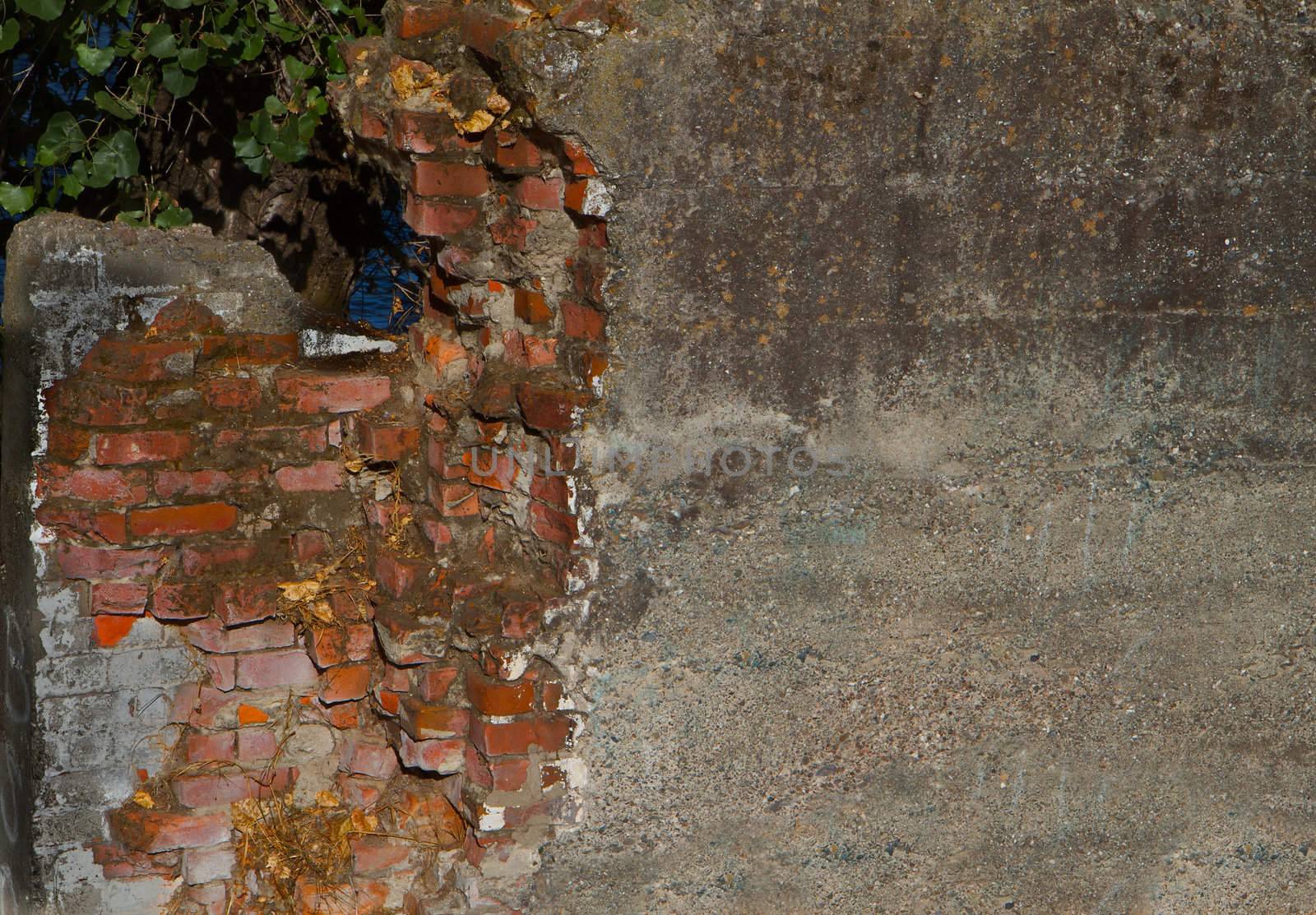 Dirty Concrete covered crumbling red brick wall