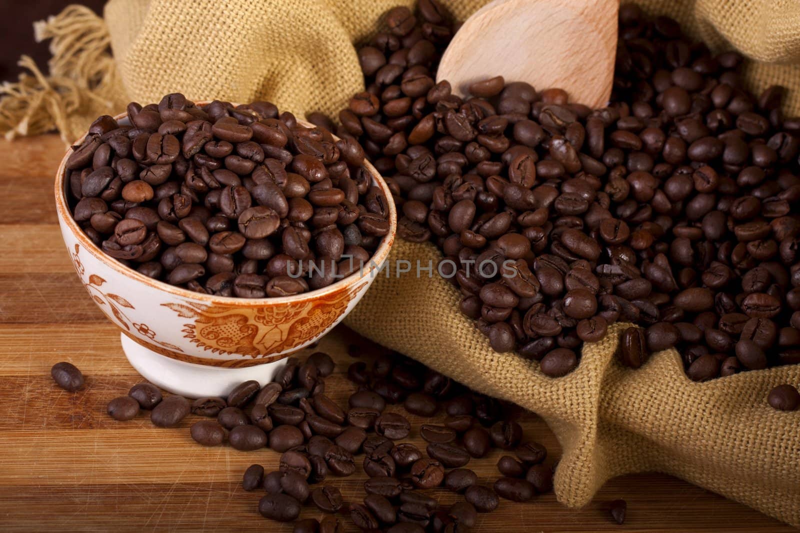 Close view of a bunch of roasted beans of coffee inside a bowl.