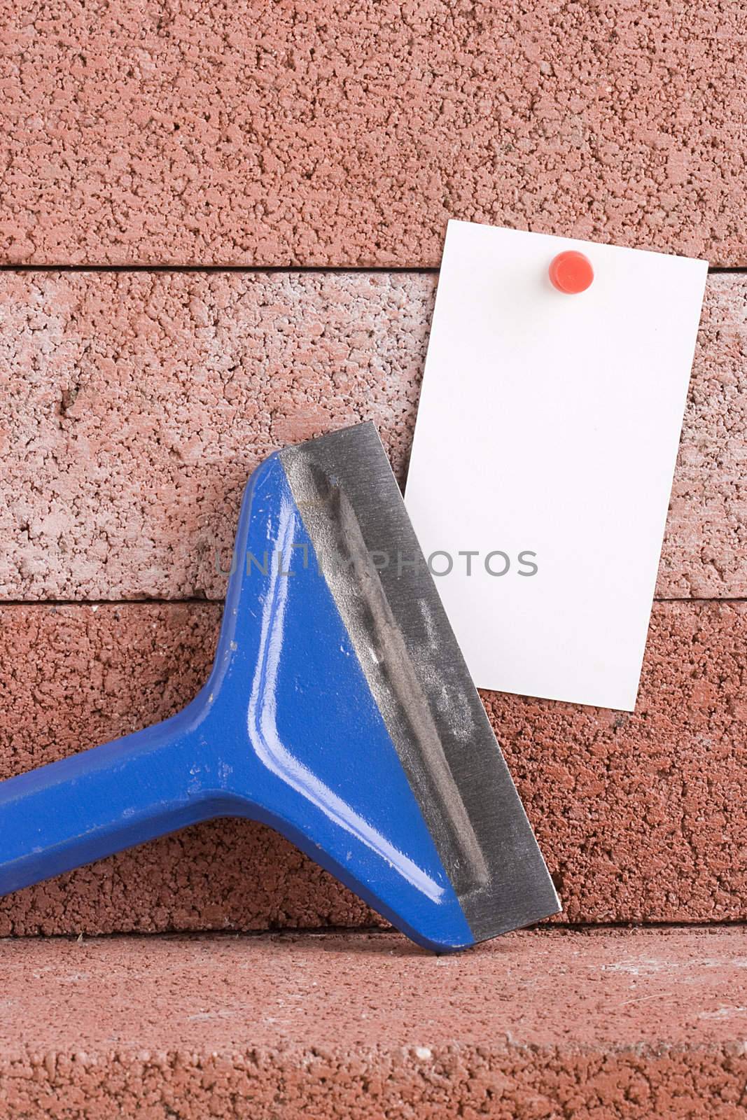 White piece of paper next to a blue chisel. Add your text to the paper.