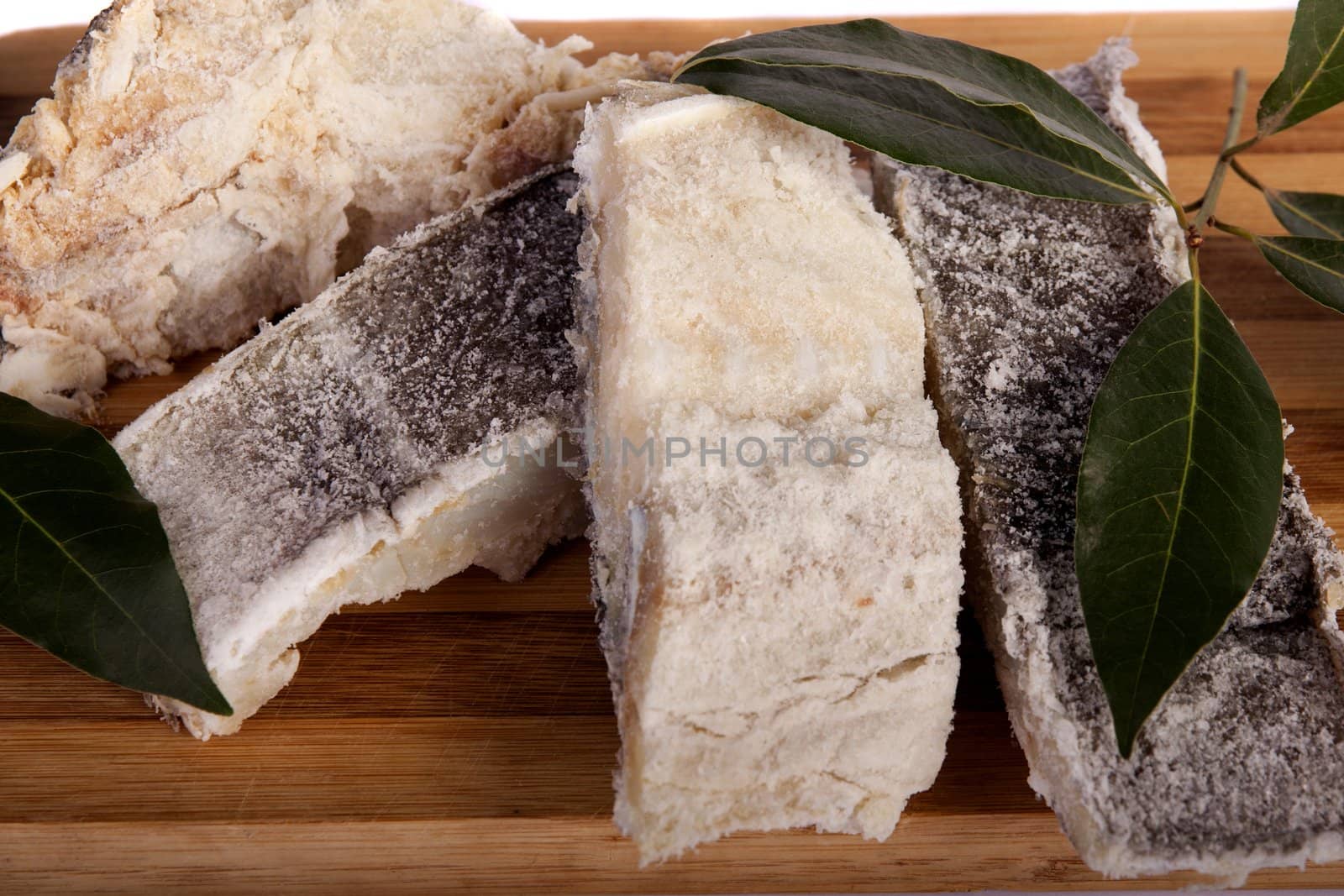 View of a bunch of sliced salted codfish isolated on a white background.