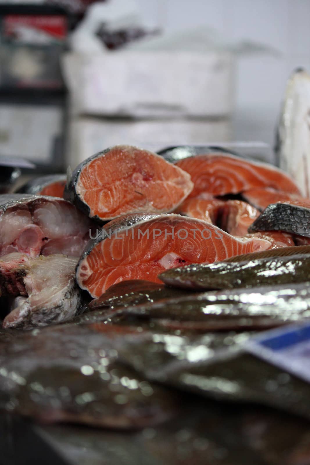 View of several fresh sliced salmon fish at the market.