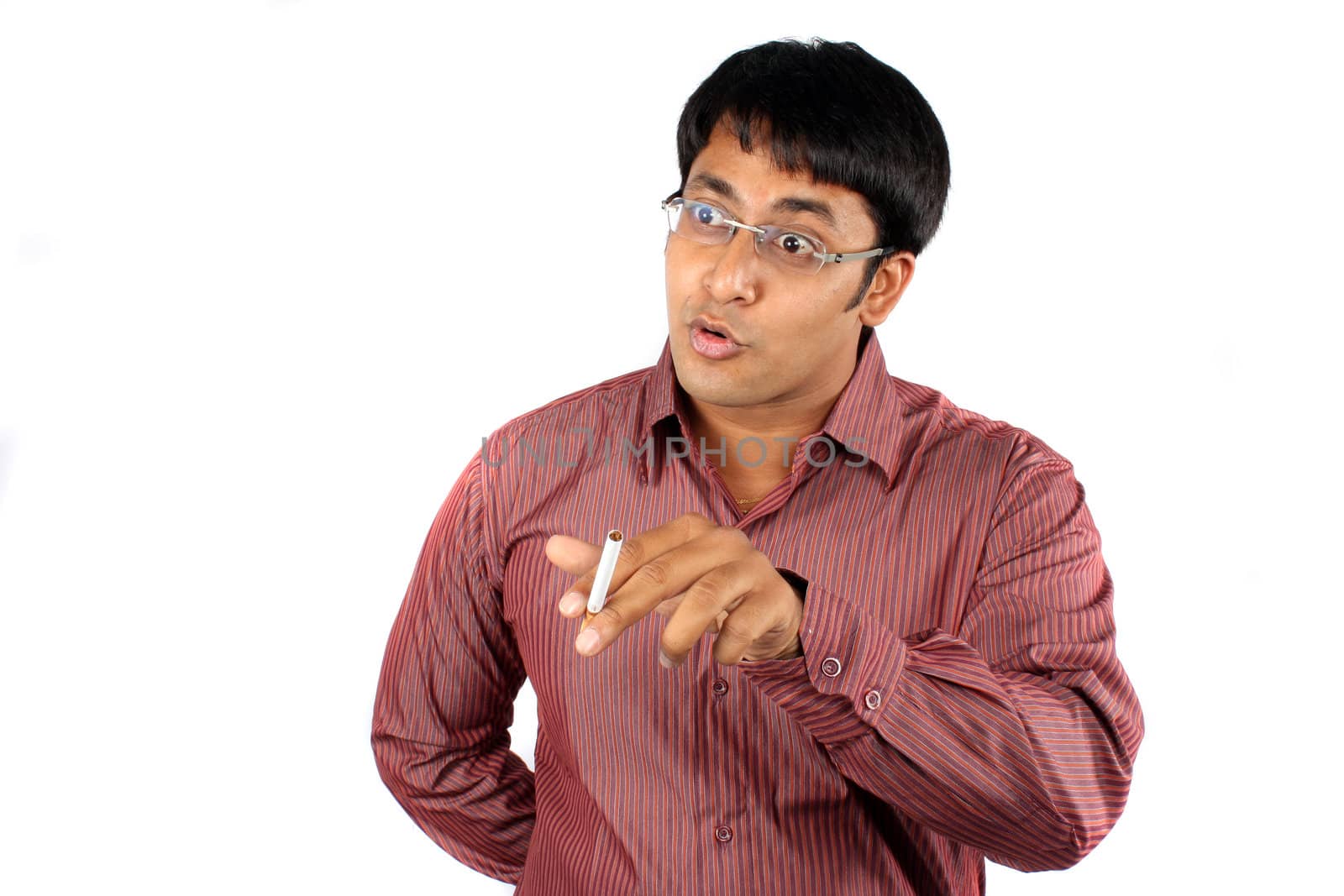 An Indian guy holding a cigarette in an argument, on white studio background.
