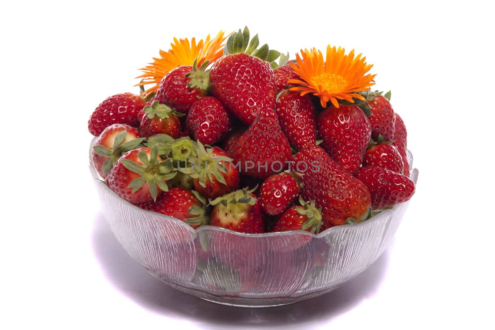 View of a bowl filled with strawberries isolated on a white background.