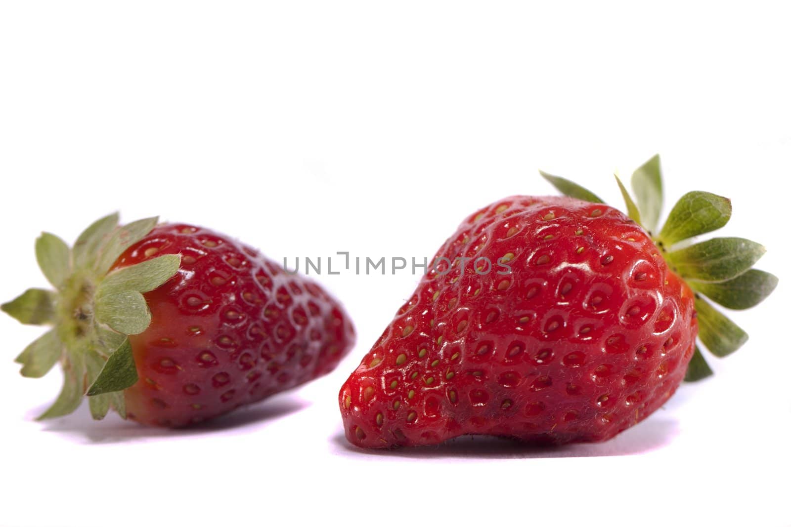 Close view of strawberries fruits isolated on a white background.