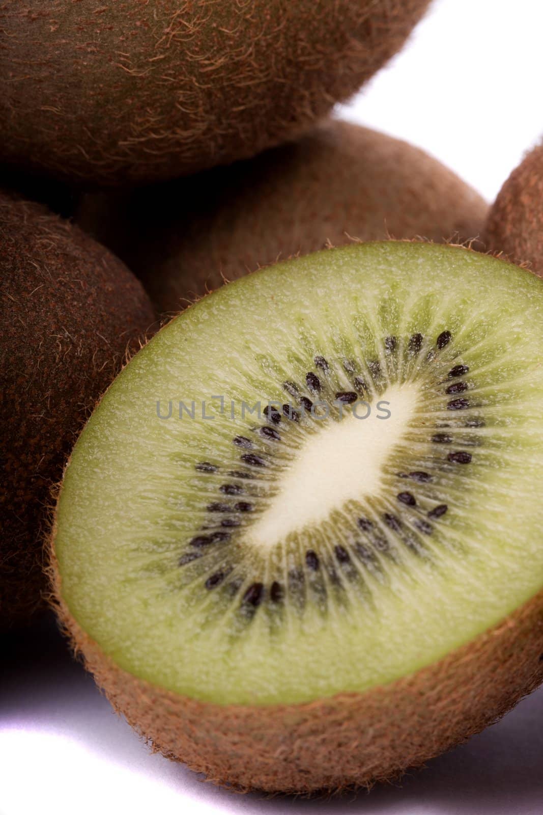 close view of a bunch of kiwi fruit isolated on a white background.