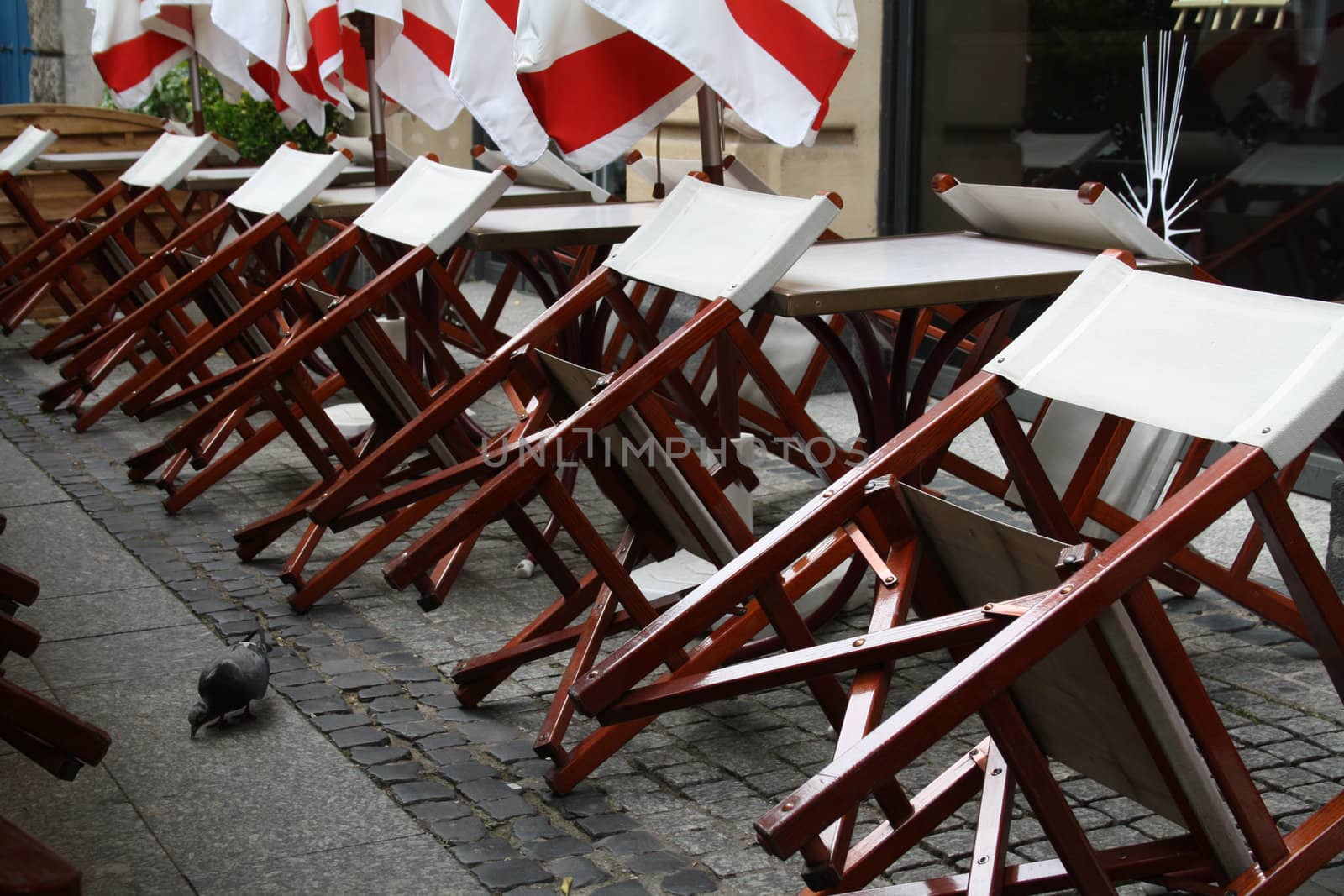 The work have finished on an outside restaurant area. Selective focus on first table and chairs.