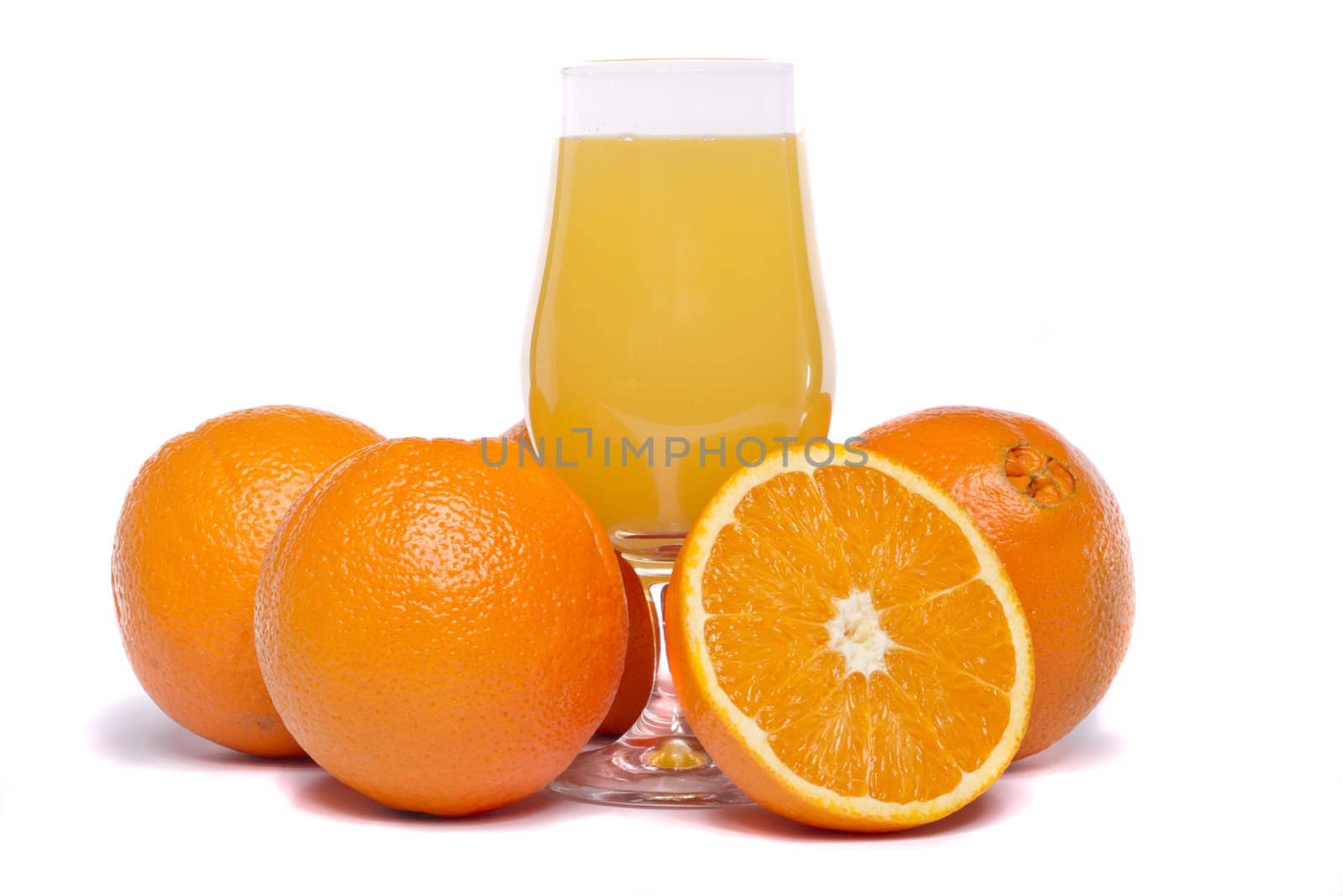 Close view of a bunch of oranges with glass of juice isolated on a white background
