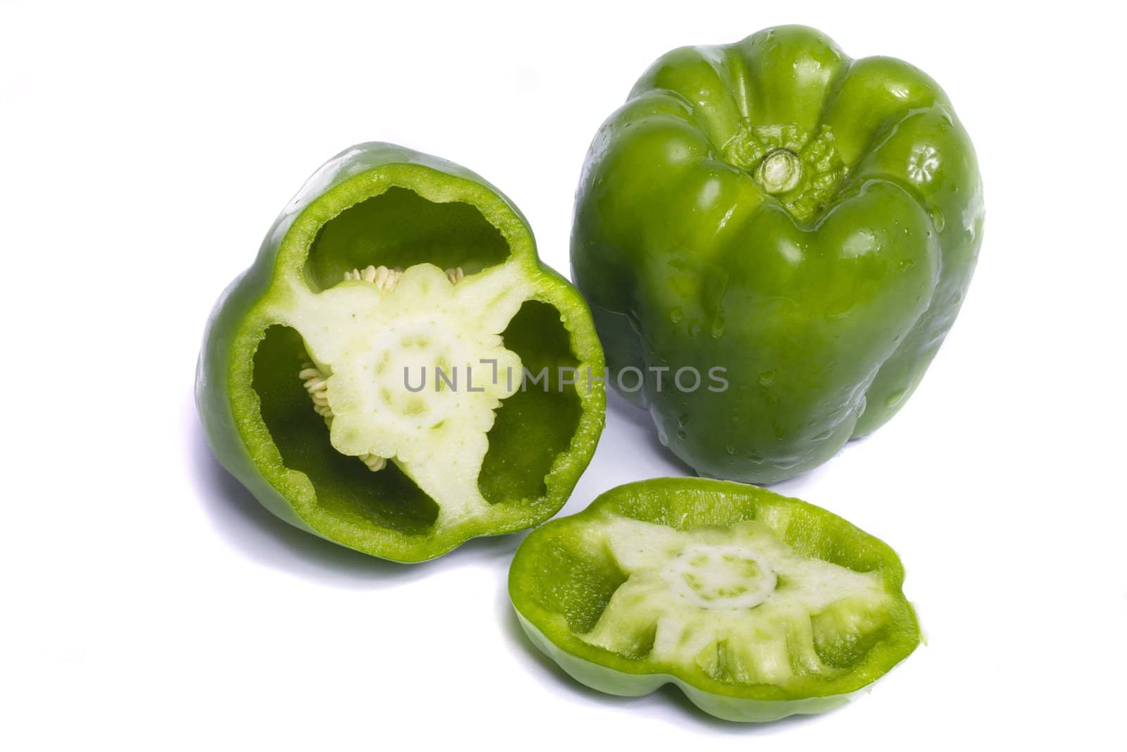 Close view of a green bell pepper isolated on a white background.