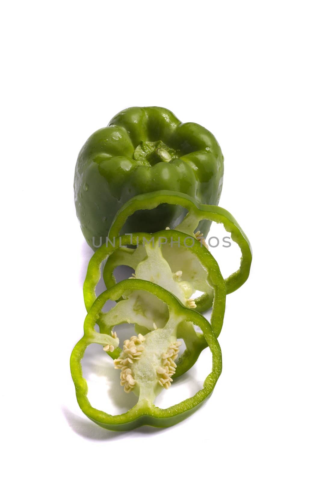 Close view of a green bell pepper isolated on a white background.