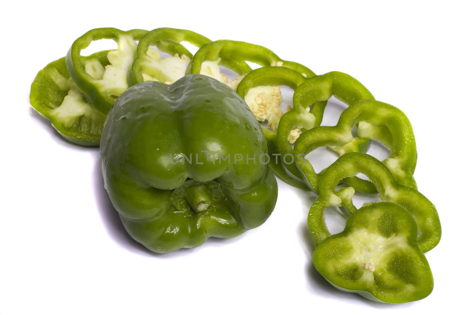 Close view of a green bell pepper isolated on a white background.