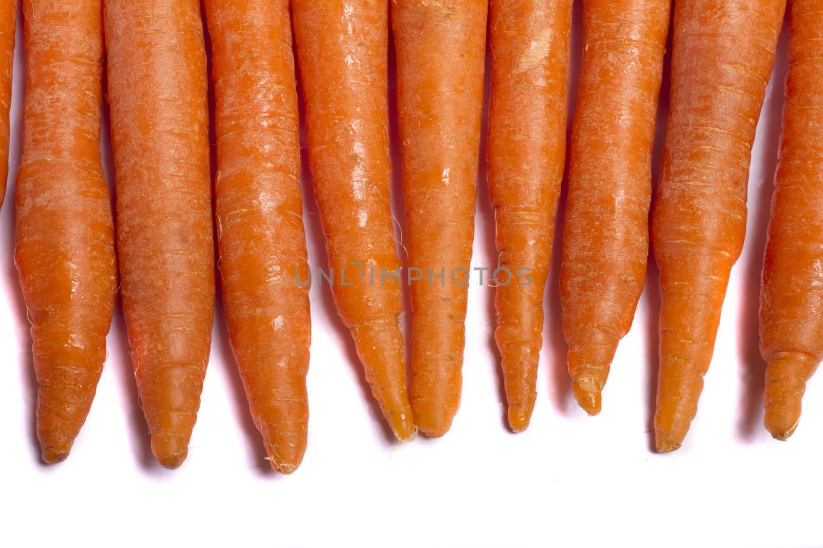 Close up view of a bunch of carrots isolated on a white background.