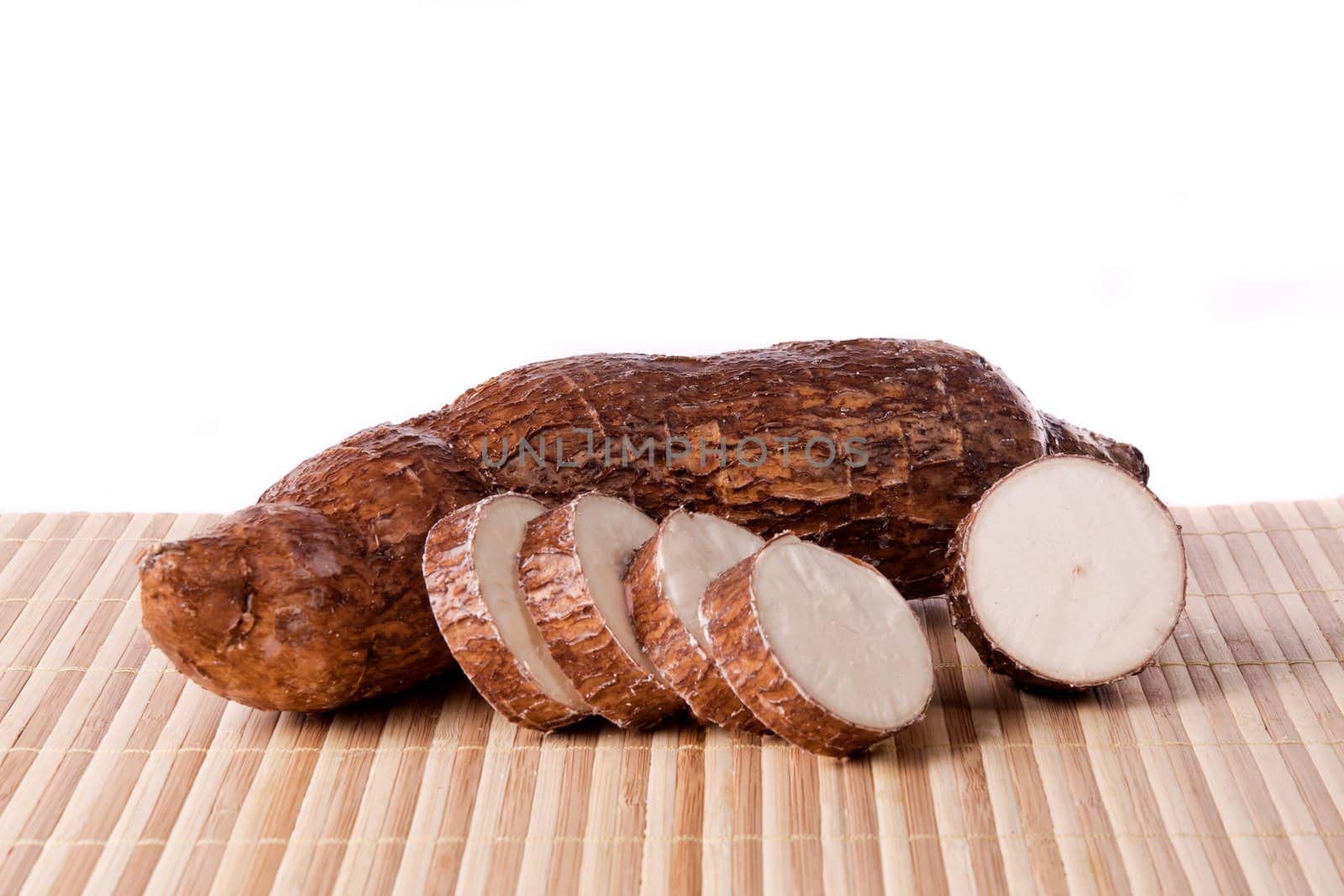 Close up view of the cassava root isolated on a white background.