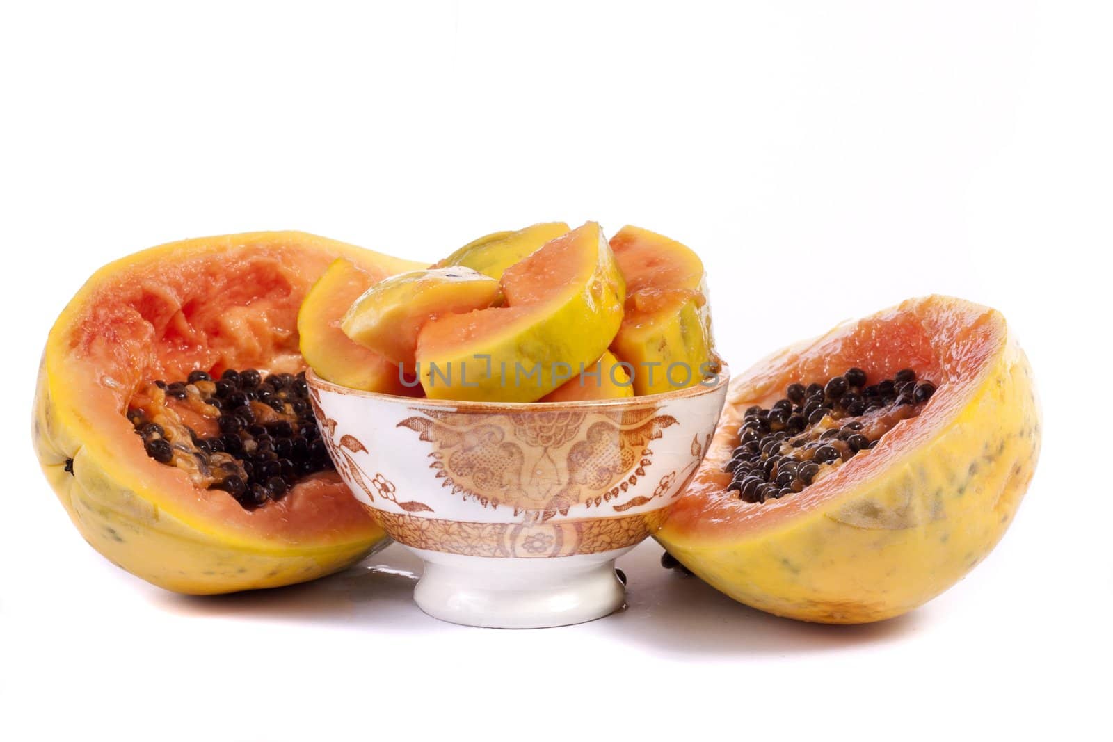 Close up view of papaya fruit sliced presented on a bowl. 