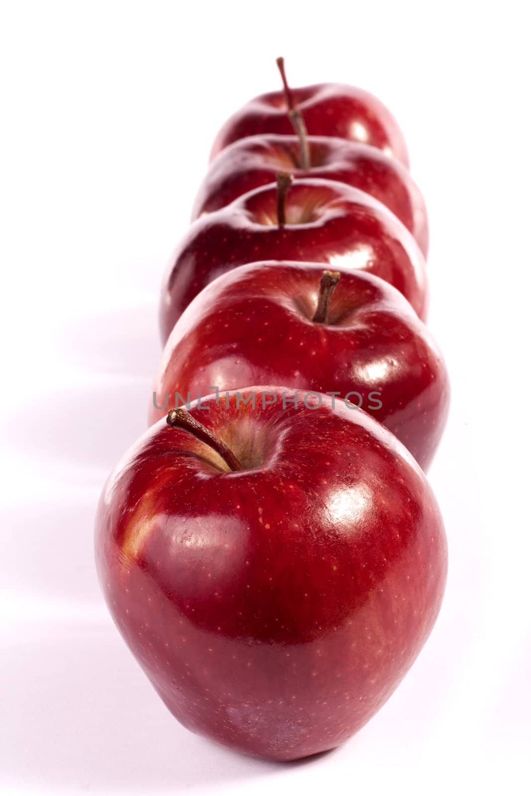 Close up view of some red apples isolated on a white background.