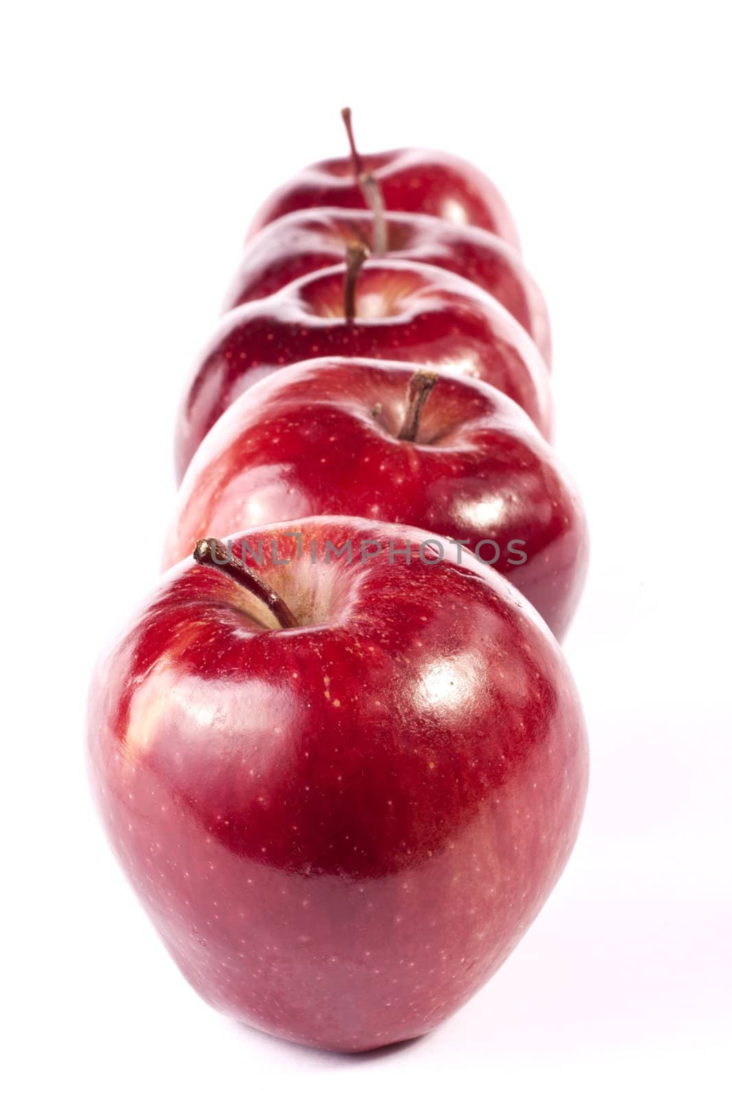 Close up view of some red apples isolated on a white background.