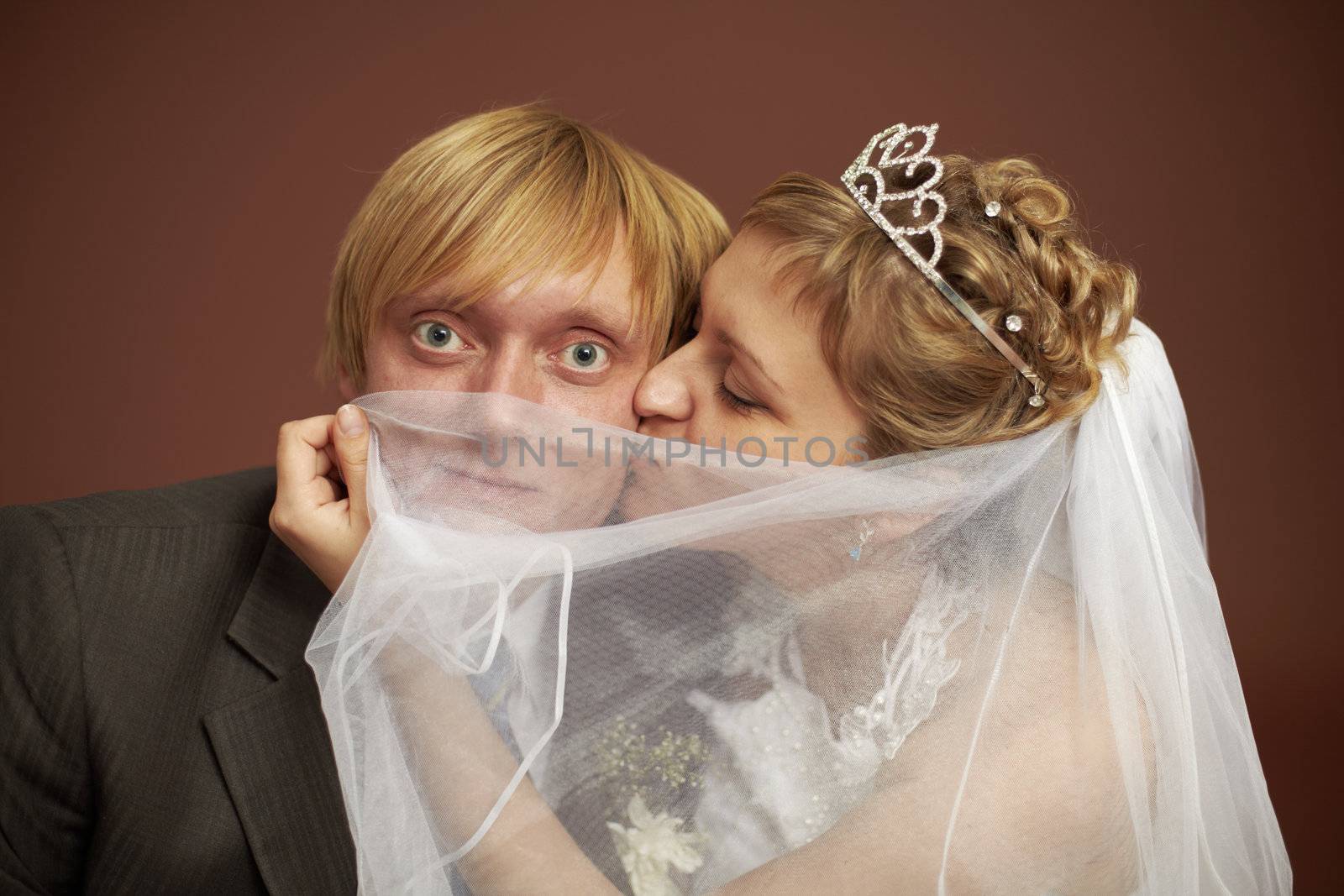 Funny bride and groom were closed veil