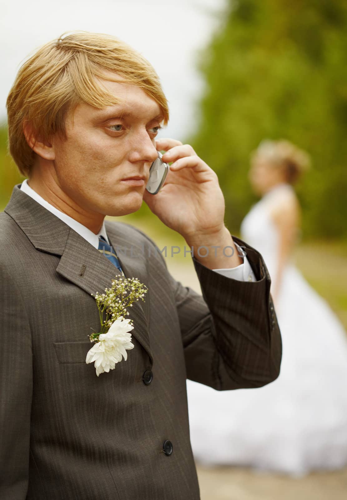 The groom speaks by phone having forgotten about the bride