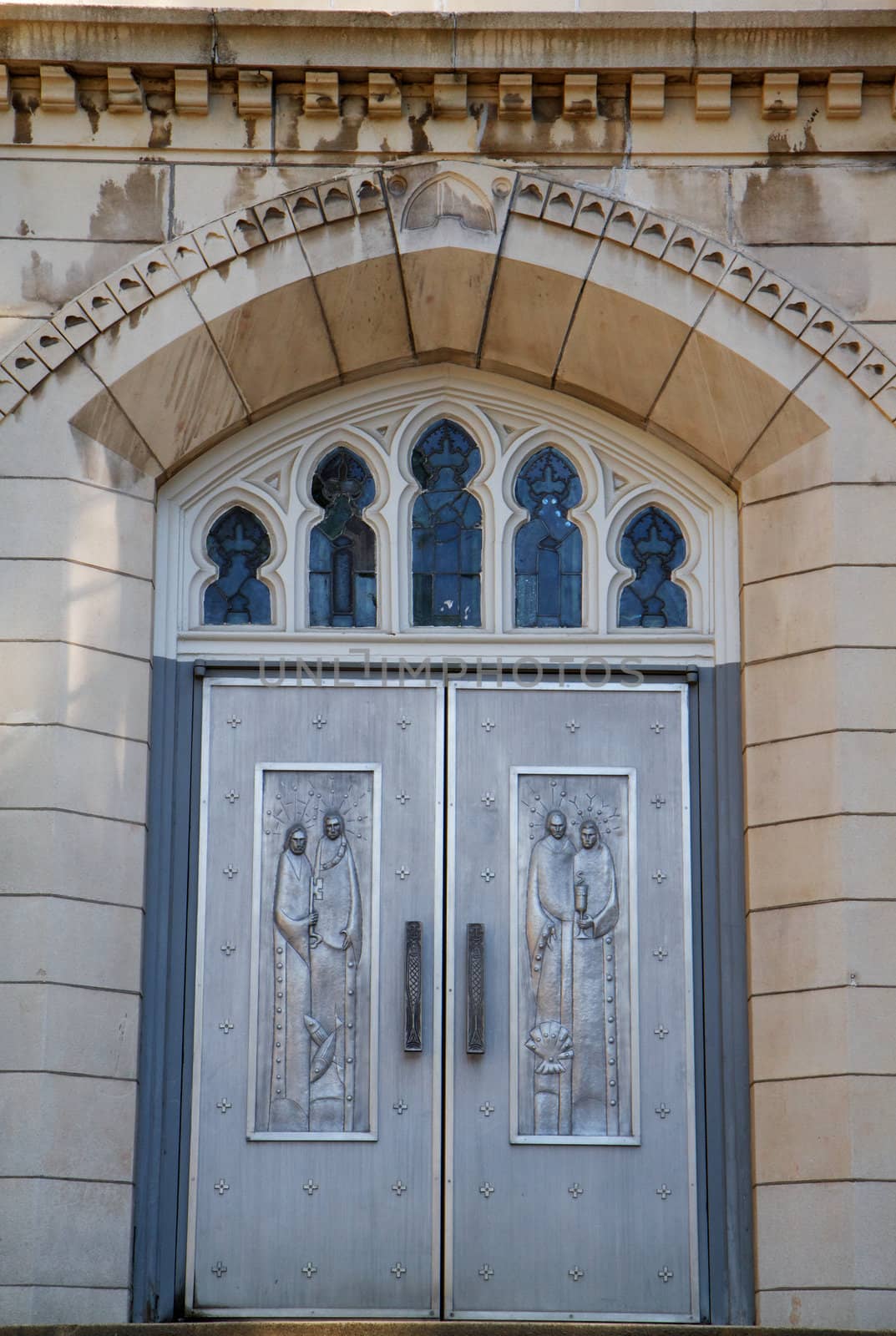 Engraves metal chruch doors with concrete steps