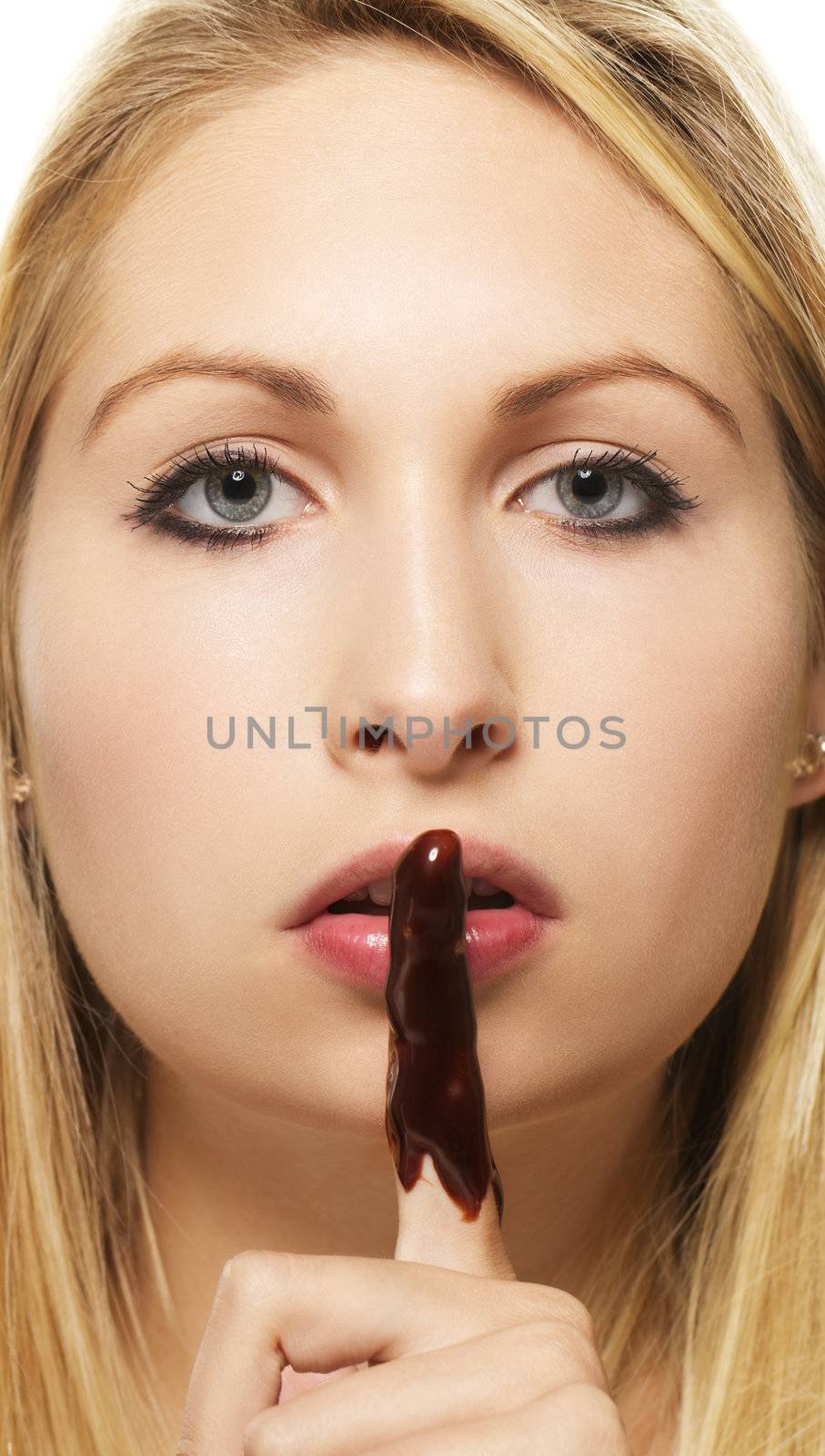 beautiful blonde woman with chocolate covered finger on white background