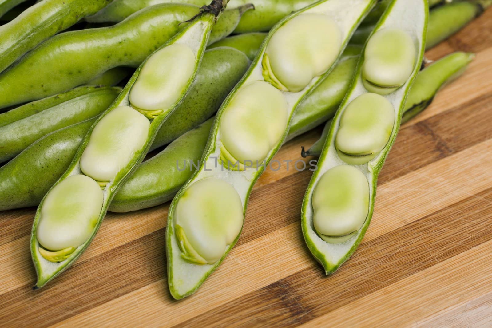 Close up view of some broad beans isolated on a white background.