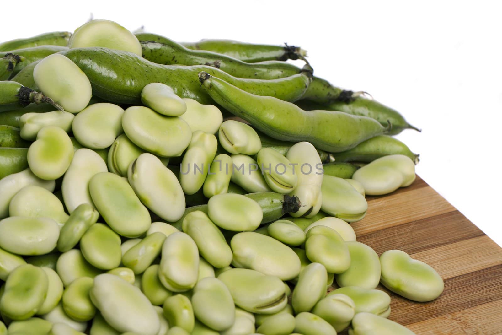 Close up view of some broad beans isolated on a white background.