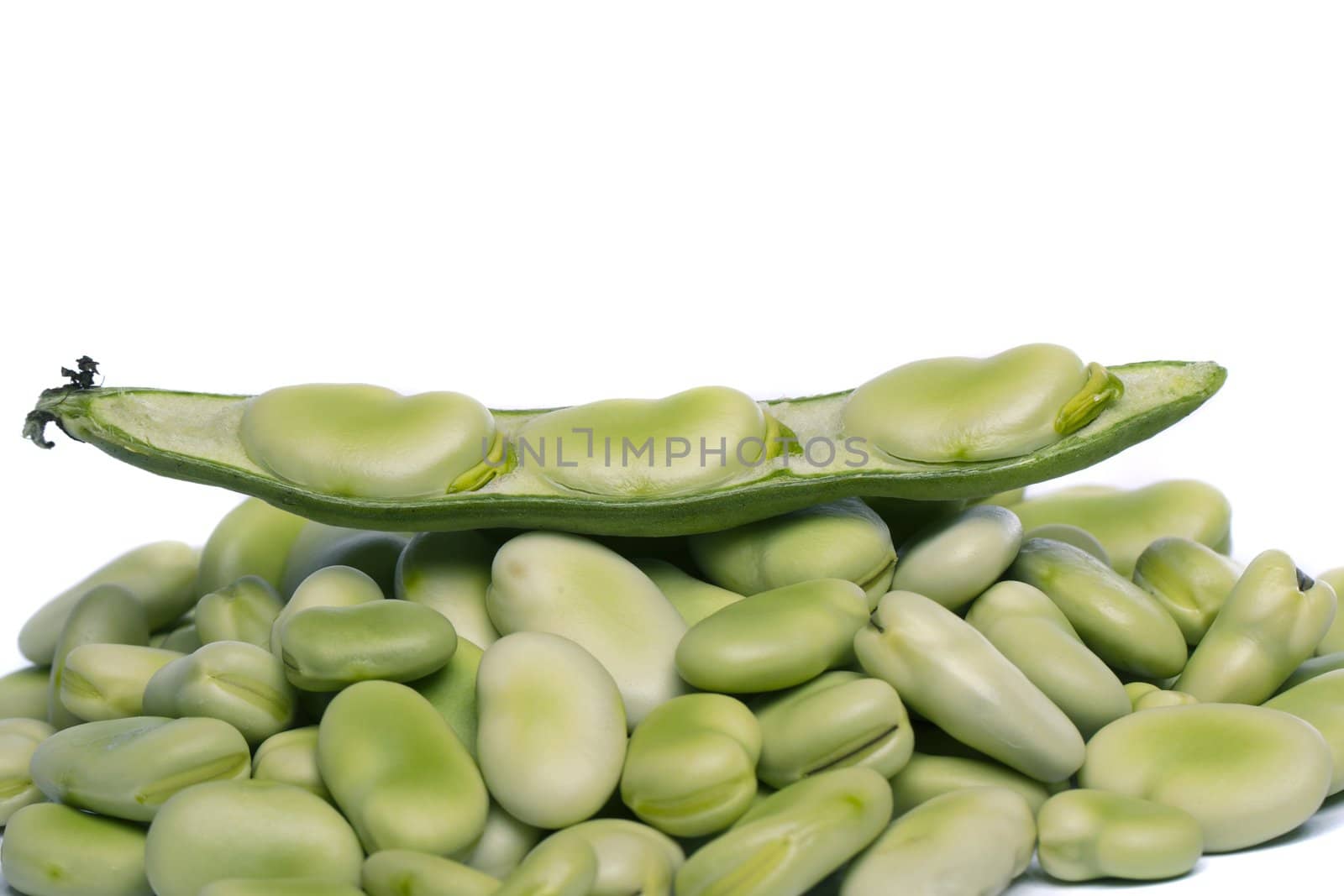 Close up view of some broad beans isolated on a white background.