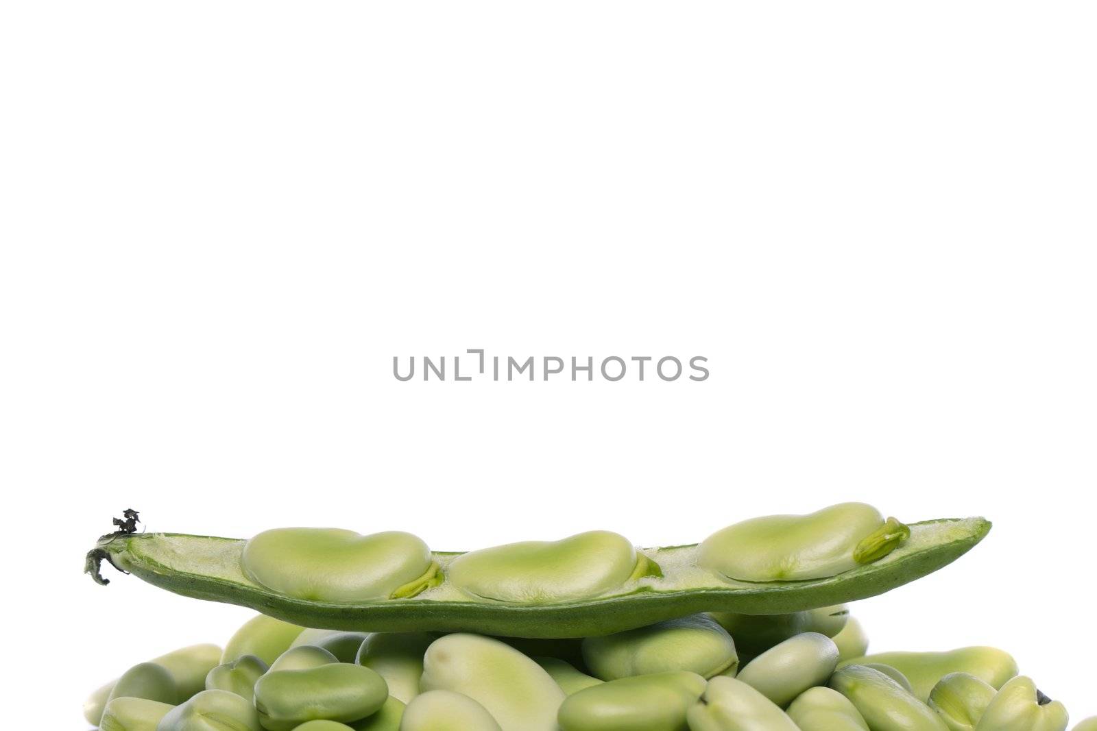 Close up view of some broad beans isolated on a white background.