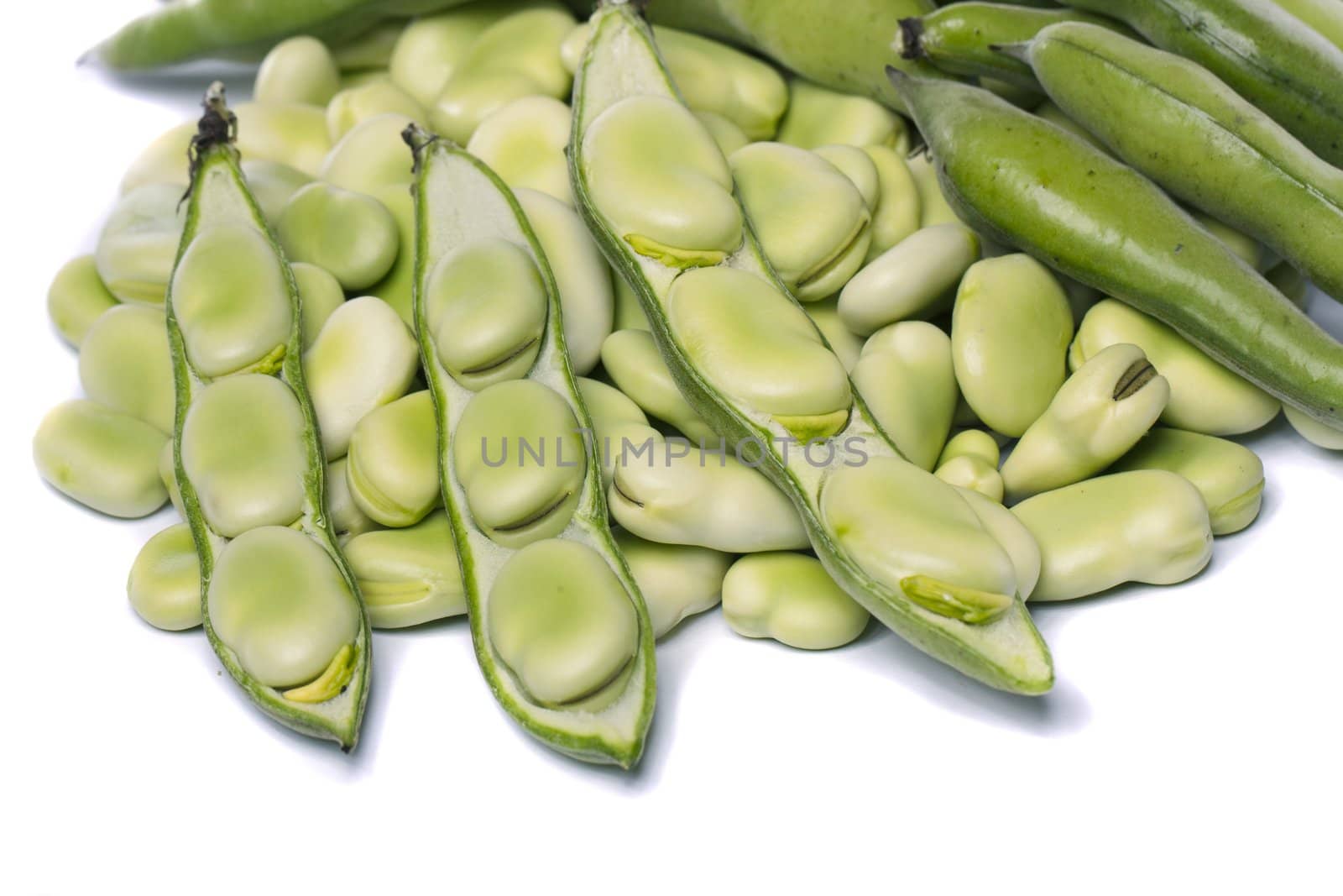 Close up view of some broad beans isolated on a white background.