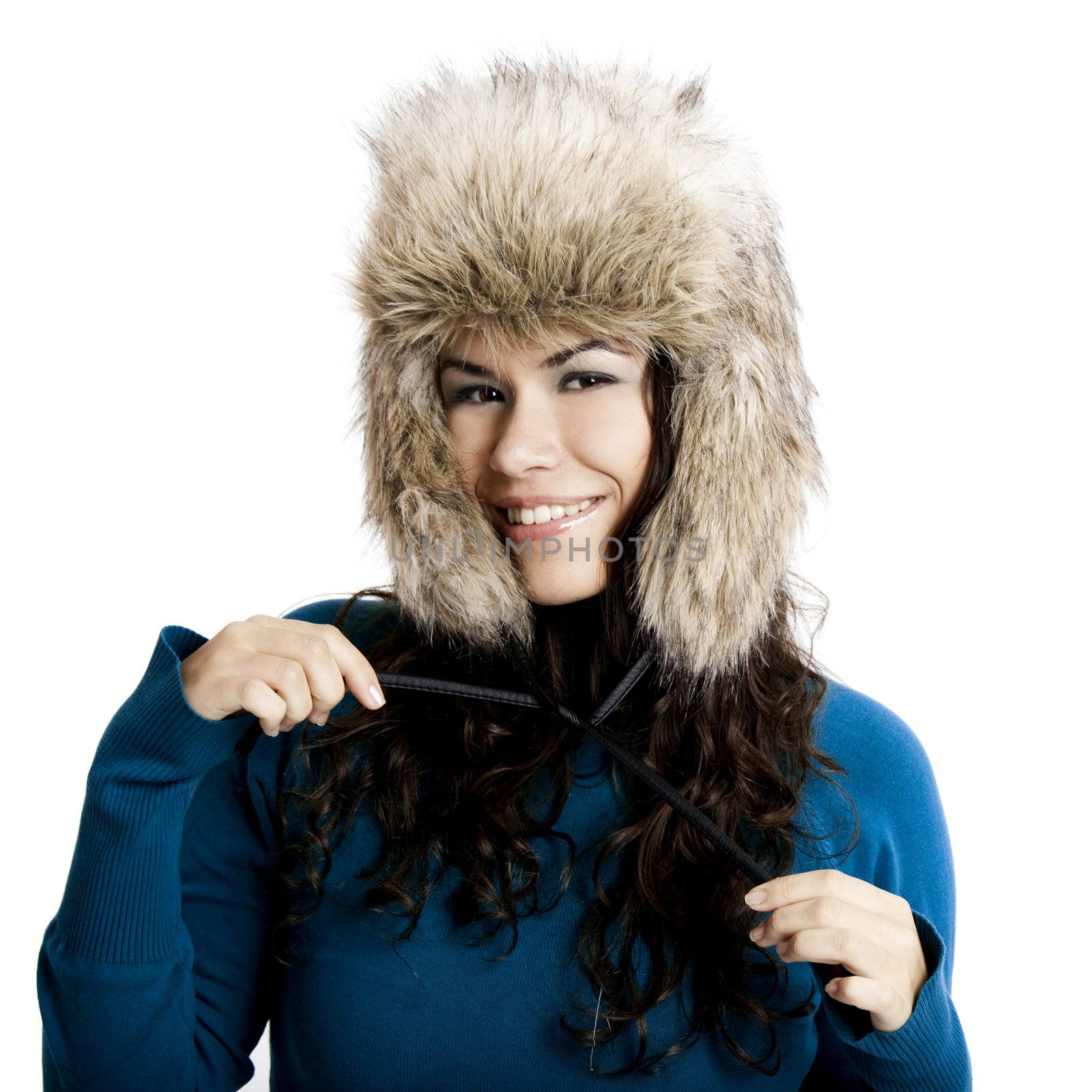 Beautiful and happy  young woman isolated on white and wearing a fur hat