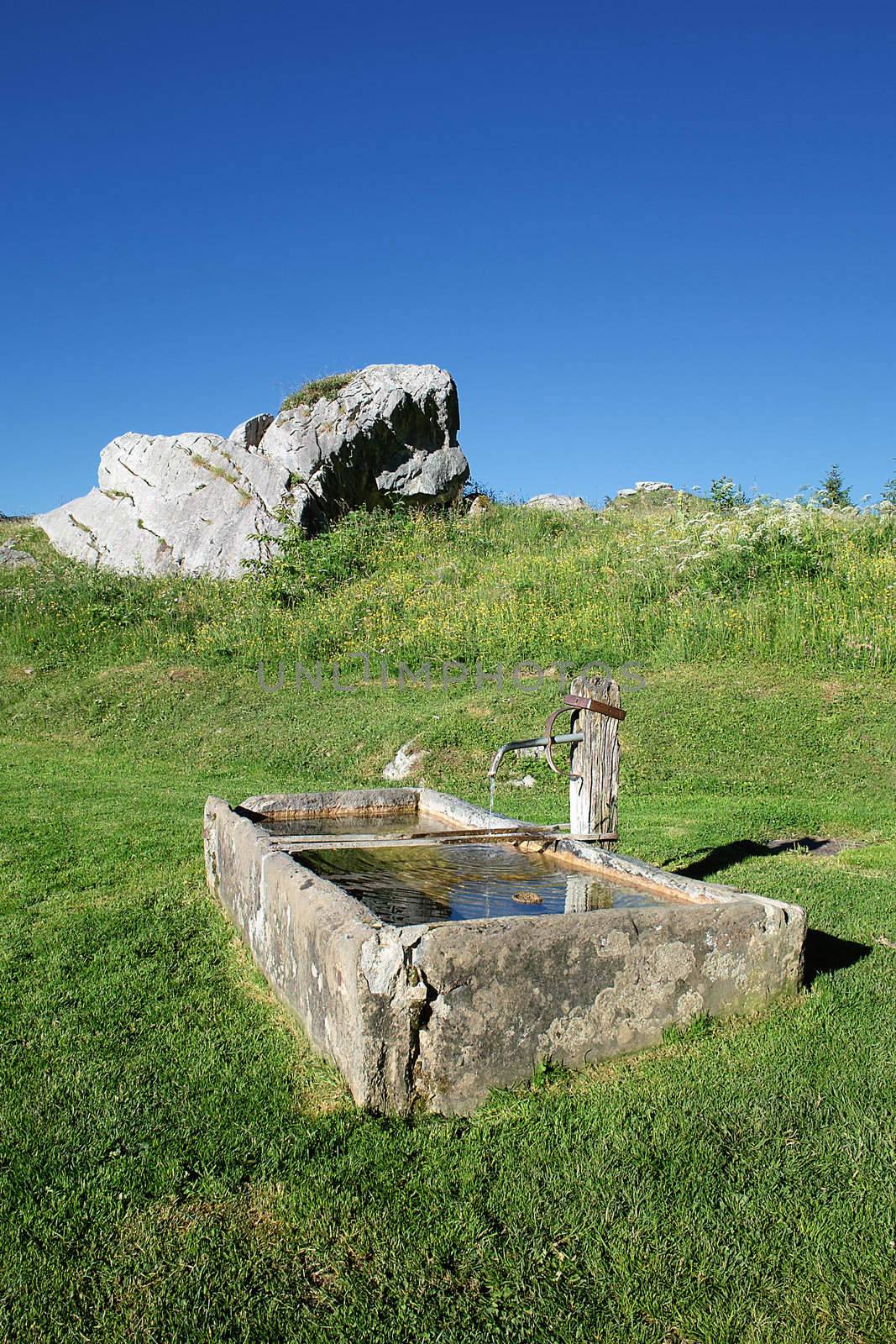 Fountain with drinking water in alpine mountain 