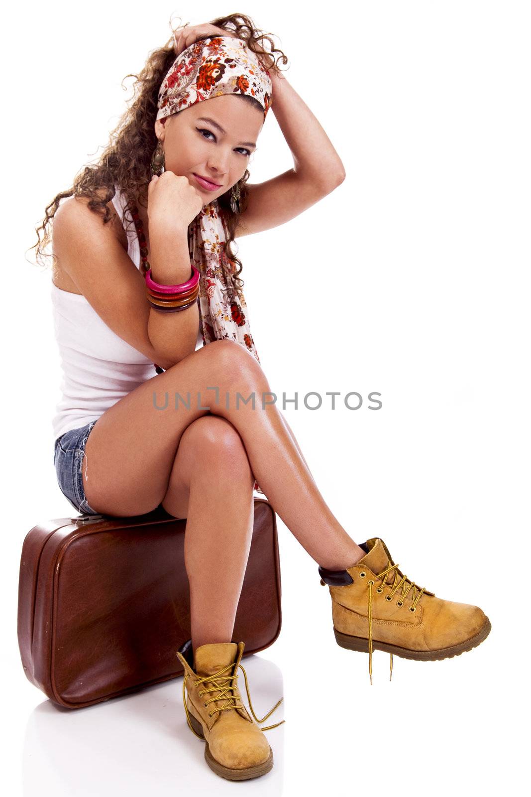 Beautiful and young fashion woman with a old suitcase, isolated on white background