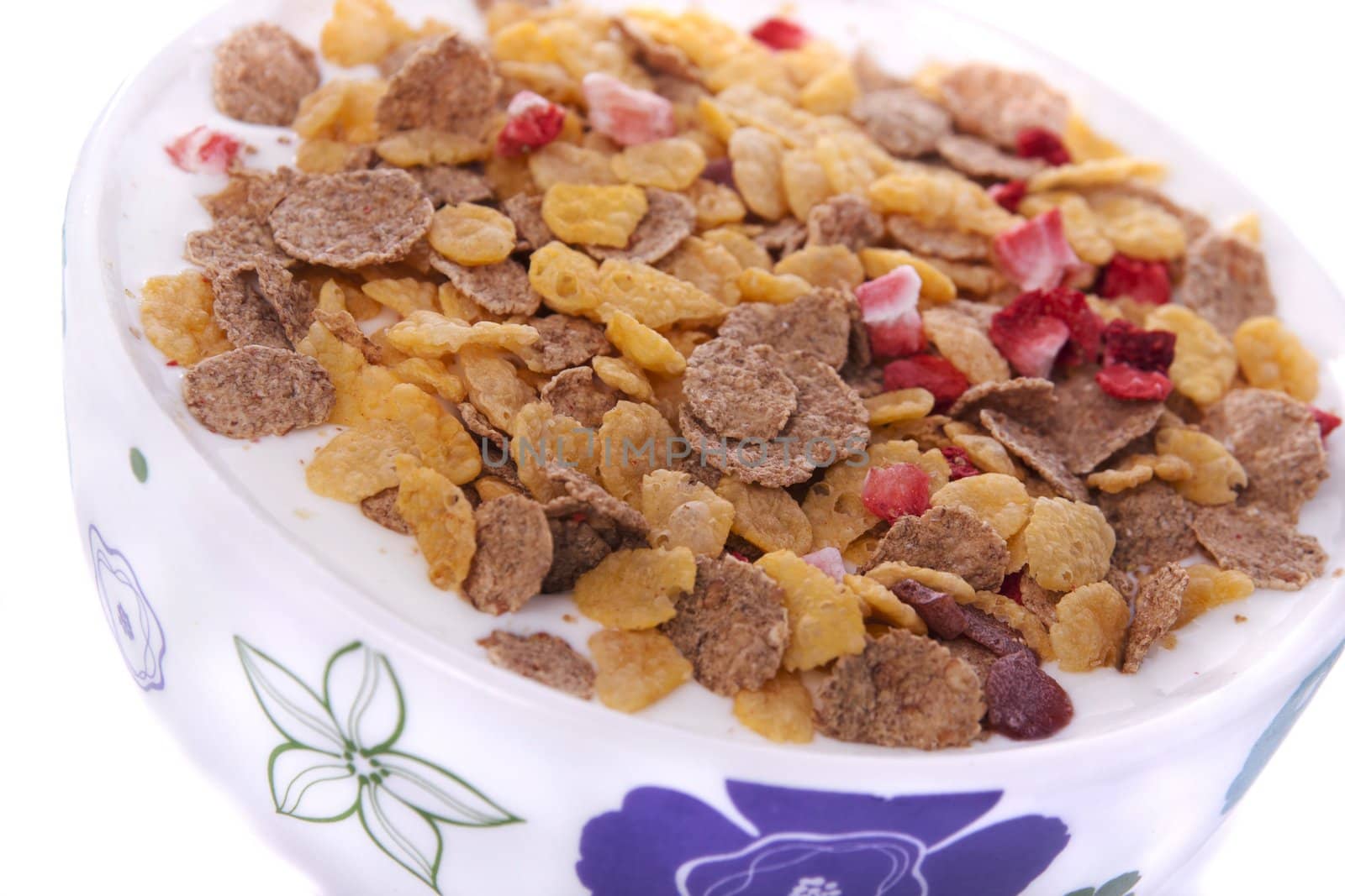 Detail view of a bowl of breakfast cereals isolated on a white background.