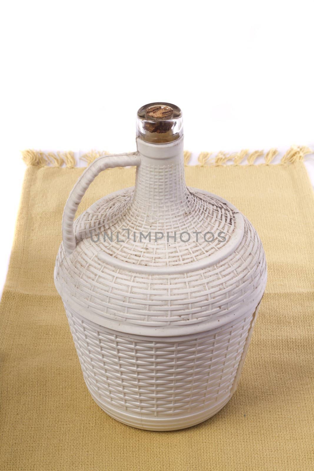 Close up view detail of a 5lt Portuguese wine bottle isolated on a white background.