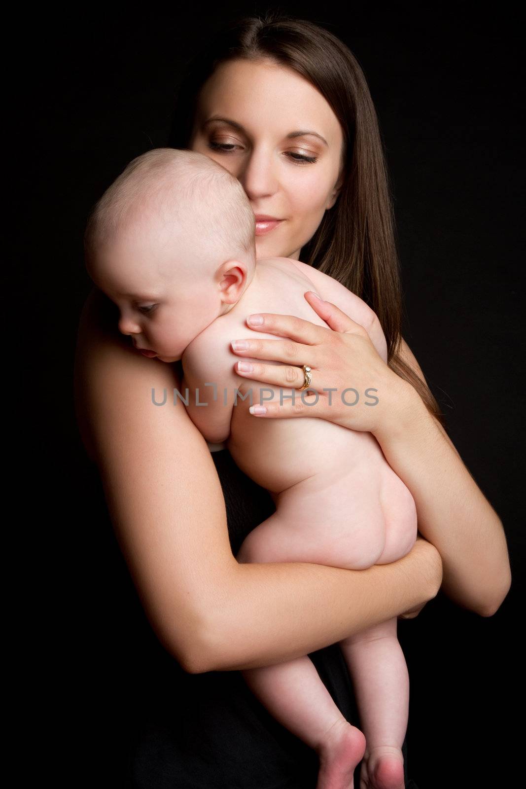 Beautiful mother holding naked baby