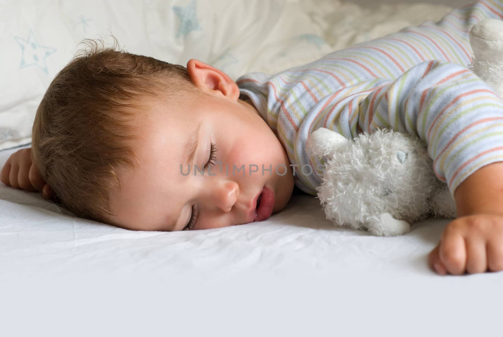 Sweet dream - little boy sleeping with white bear